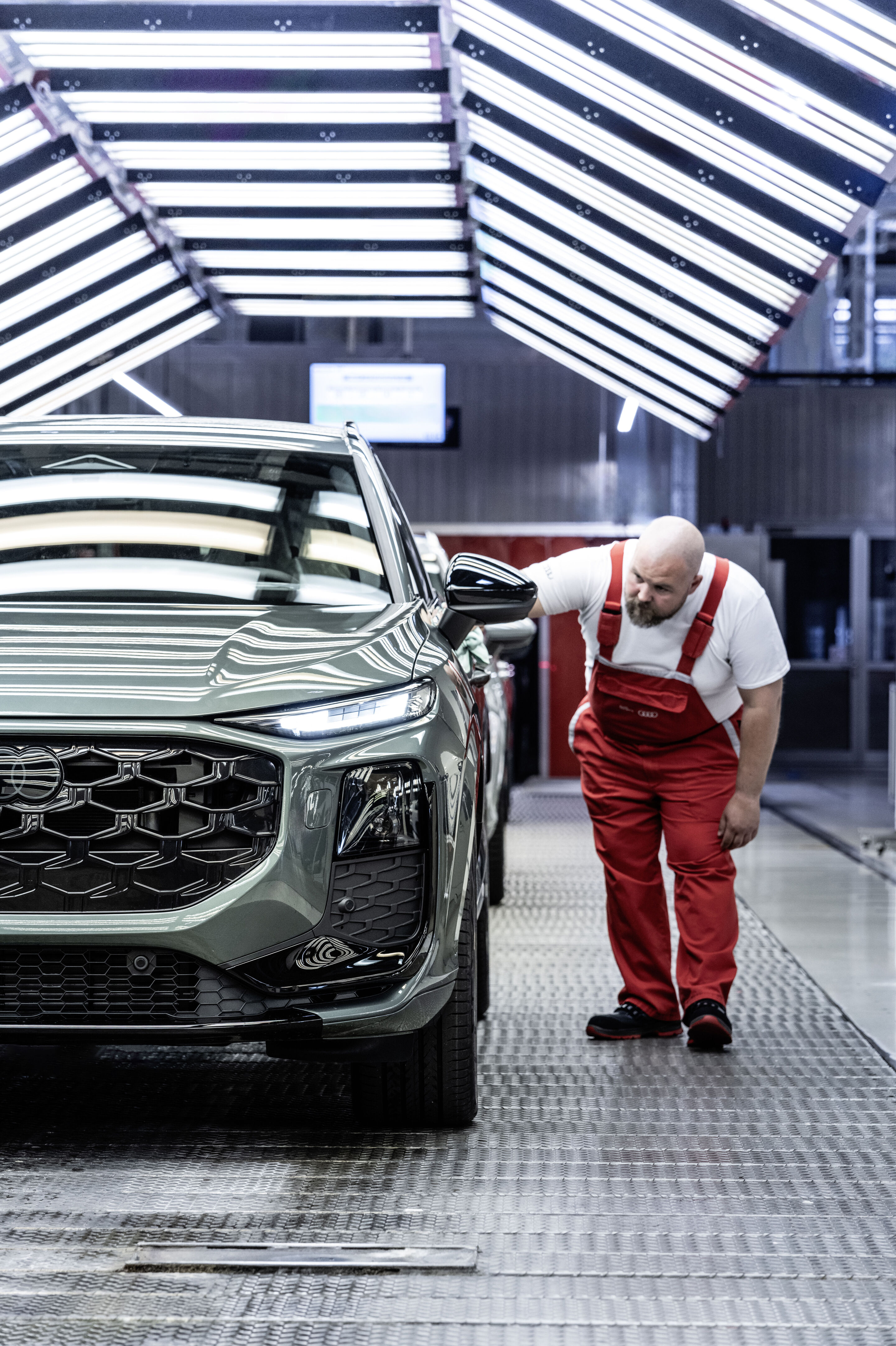 Audi Q3 SUV - The Audi Q3 is manufactured at Audi Hungaria in Győr. Pictured: Vehicle assembly, finish and surface inspection, Colour: Sage green metallic