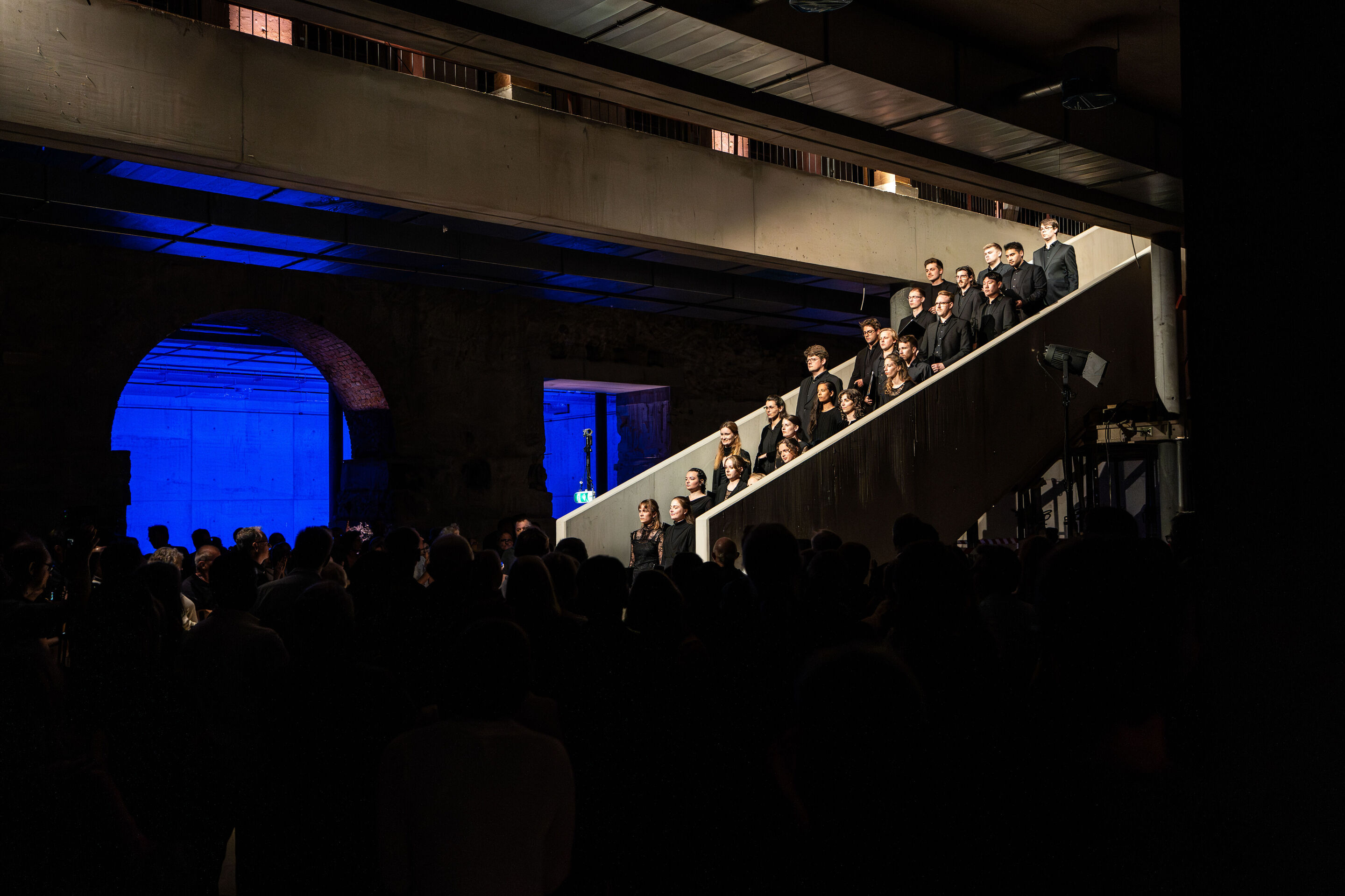 “Lux!”: Theatrical concert at the construction site of the MCAD; Arcis Saxophone Quartet, vocal ensemble LauschWerk - On the construction site of the new Museum of Concrete Art and Design Ingolstadt, the audience stands on the lower level at the bottom...
