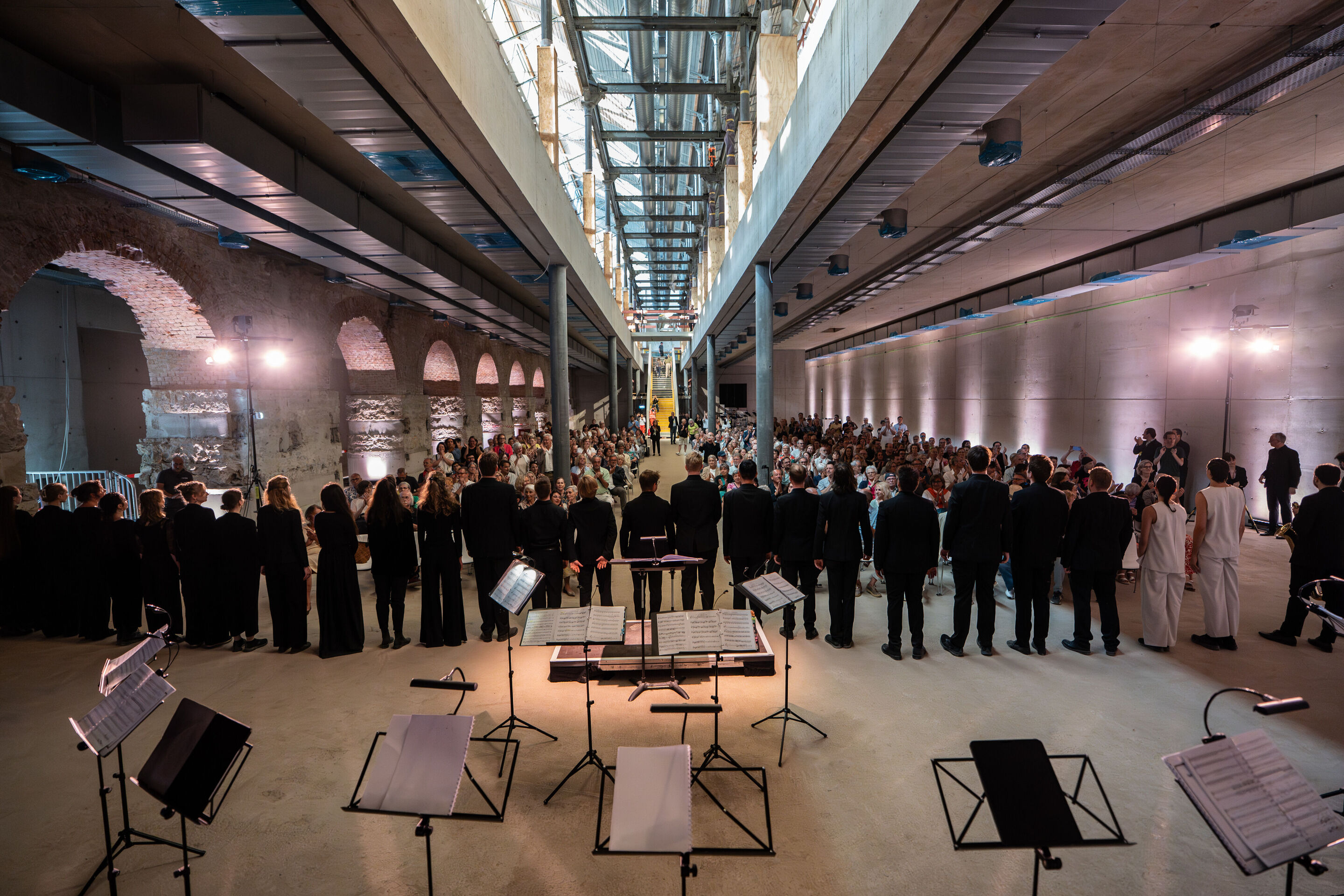 “Lux!”: Theatrical concert at the construction site of the MCAD; Arcis Saxophone Quartet, vocal ensemble LauschWerk - On the construction site of the new Museum of Concrete Art and Design Ingolstadt, the view from the back of the stage looks into the...