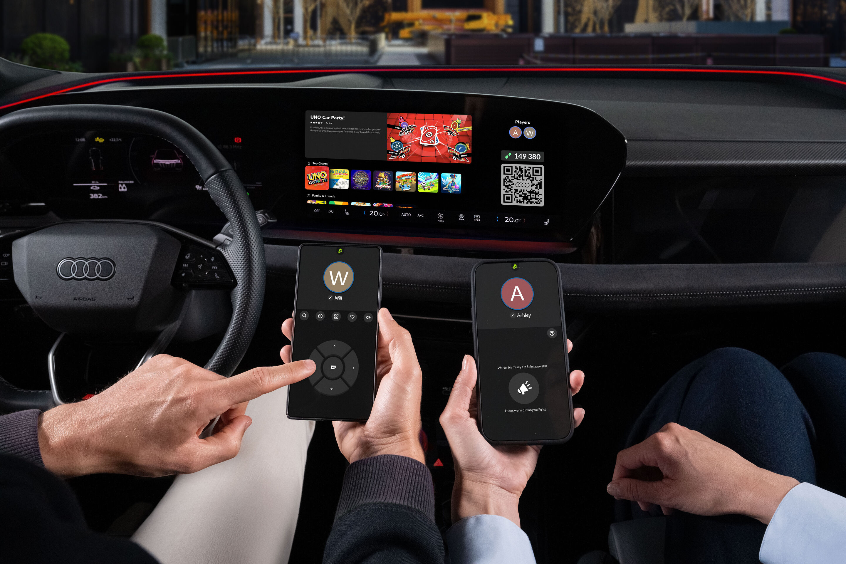 Gaming fun on the go: Audi integrates AirConsole - The AirConsole gaming platform app runs on the touch display in an Audi. The driver and front passenger each hold a smartphone in their hands in front of the display. They use the smartphones as controllers...