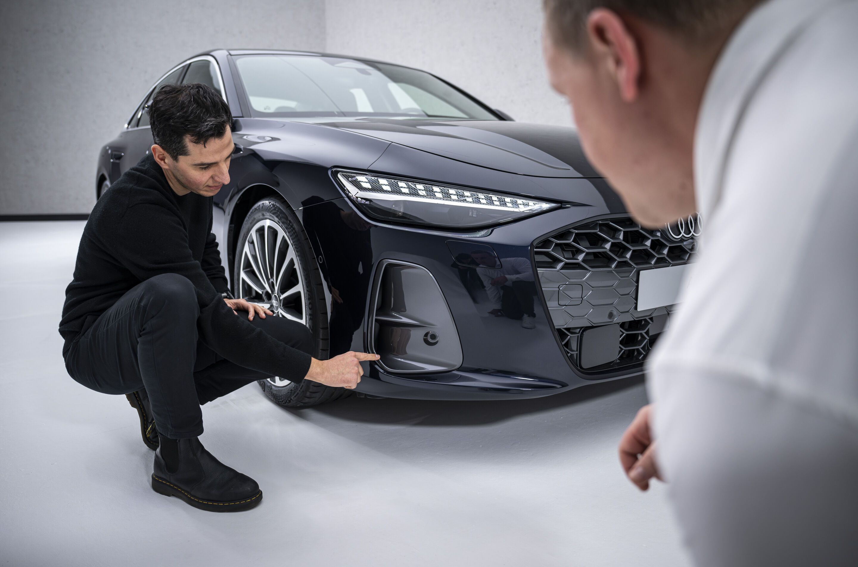 The new A6 Sedan launches across retail locations - Exterior designer Francesco d’Amore (left) shows aerodynamics developer Sebastian Weiper (right) the air curtains on the Audi A6 Sedan.