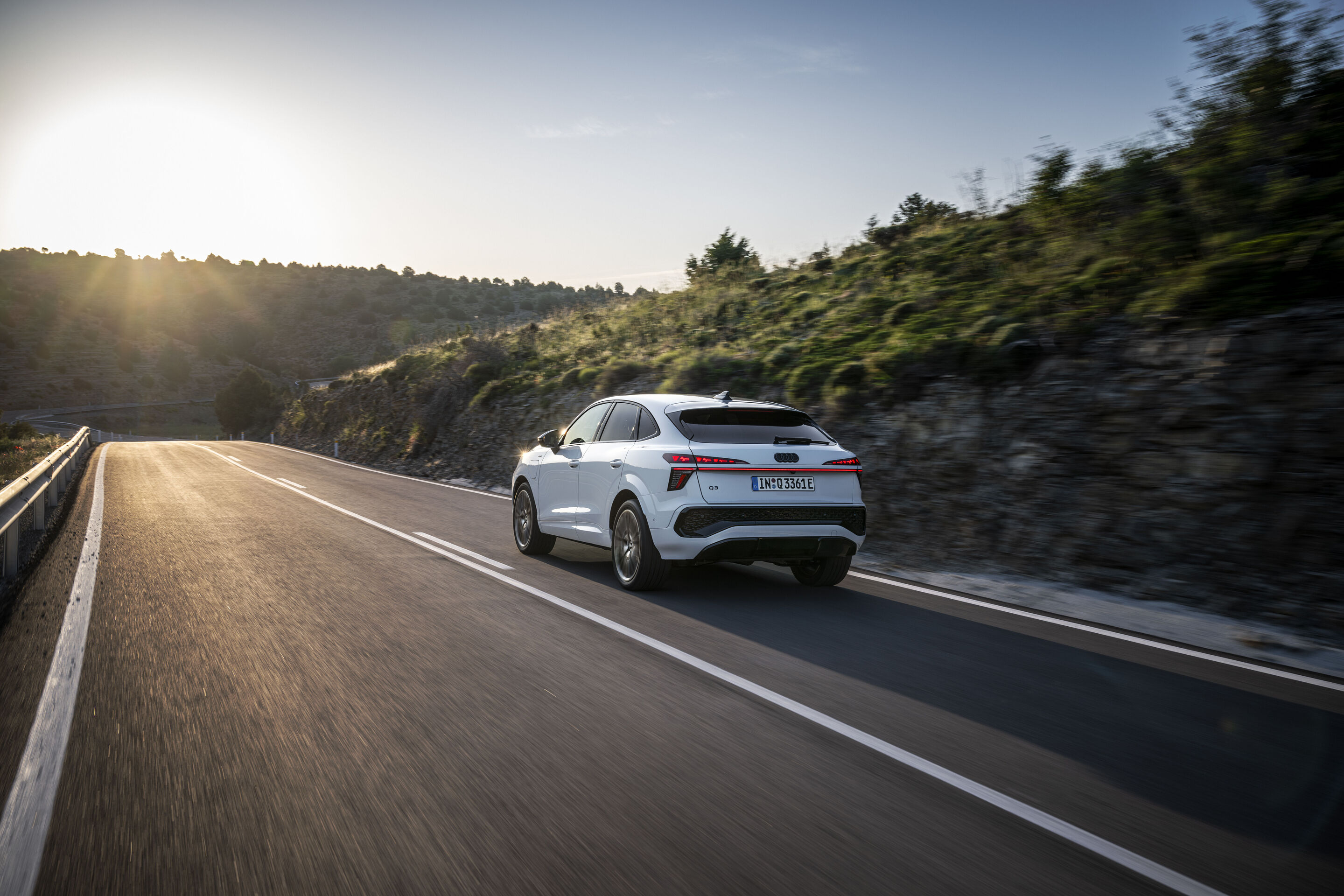 Audi Q3 Sportback e-hybrid - Glacier white metallic, dynamic outdoor shot, exterior, rear three-quarter view