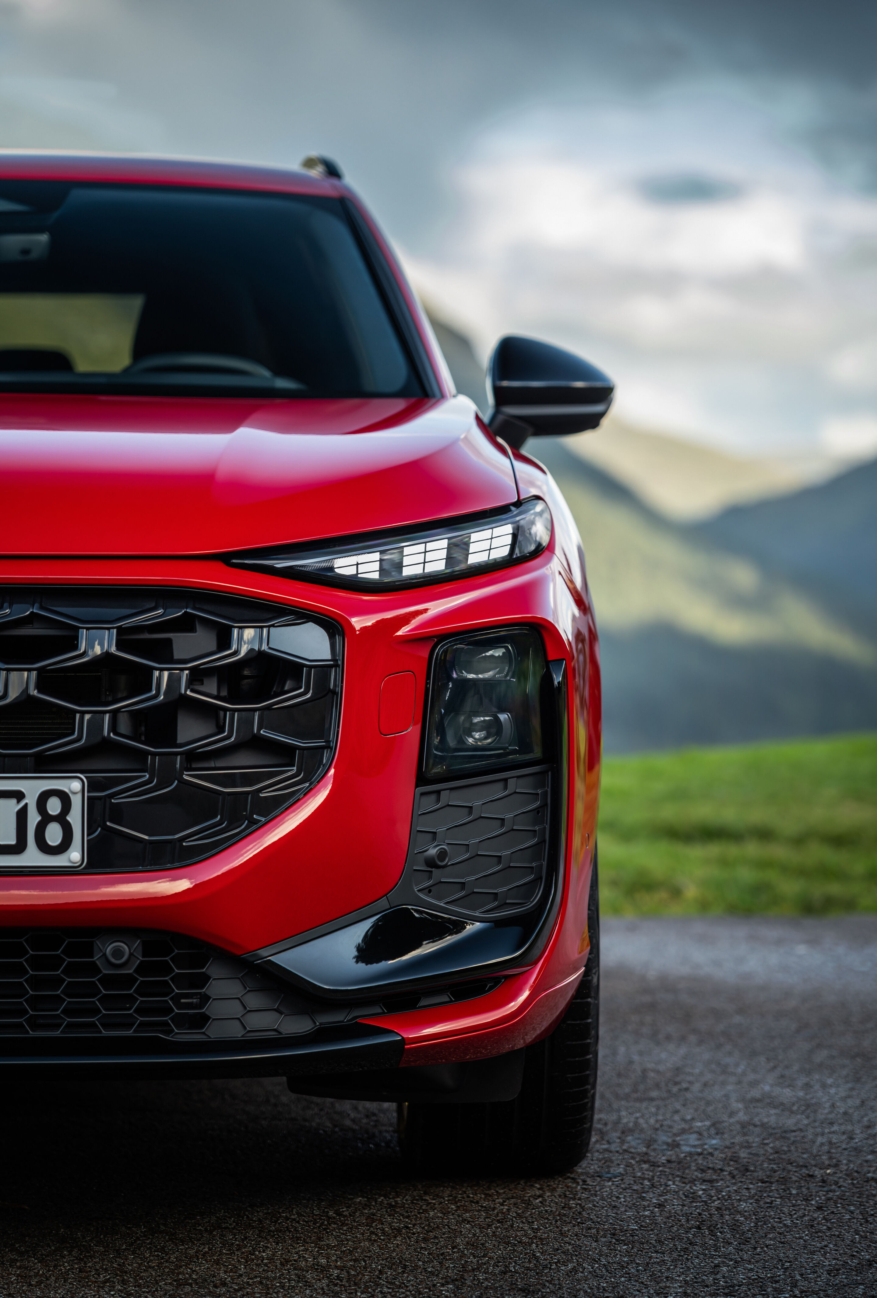 Compact class meets Celtic charm: the new  Audi Q3 in Scotland - Progressive red metallic, outdoor static photo, exterior, detailed front view