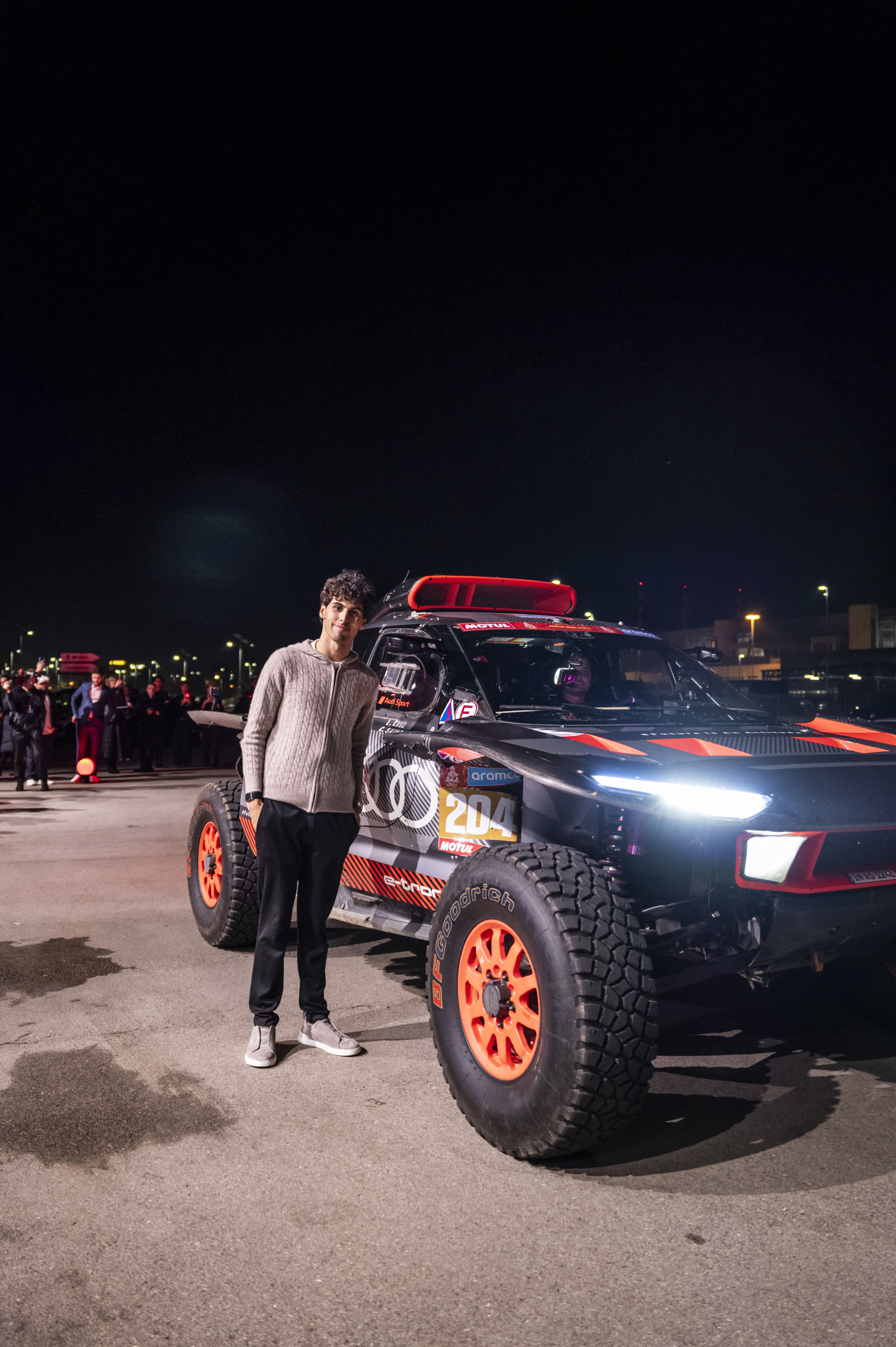 Motorsport legends welcome the Audi R26 Concept - Guests at the event “Audi One” in Munich, November 12, 2025: Gabriel Bortoleto beside the Audi RS Q e-tron (Dakar)