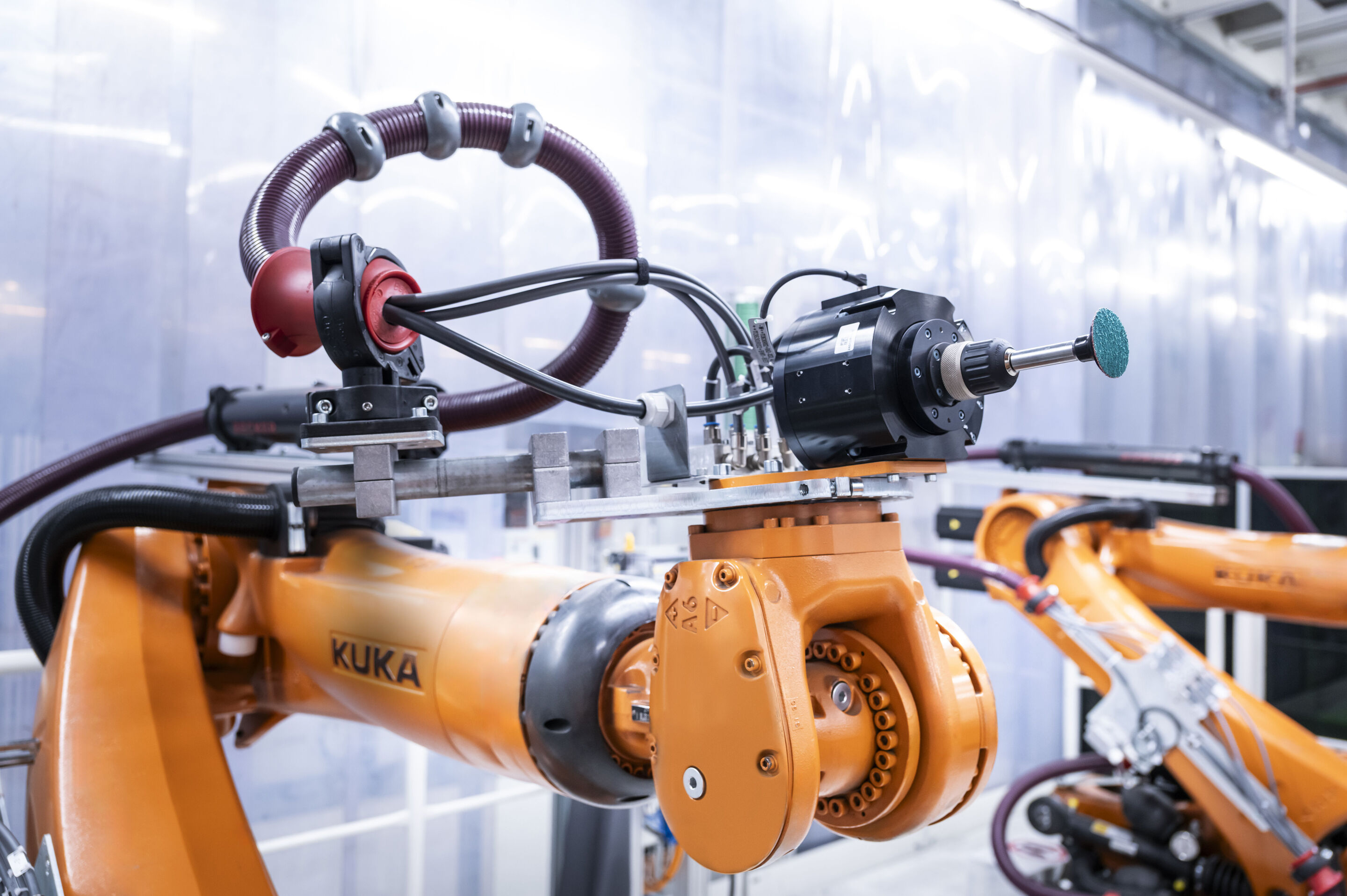 Audi scales up deployment of artificial intelligence in production - An AI application detects weld spatter on the underbody of a car body in the body shop at the Audi site in Neckarsulm, Germany. Thanks to a recent upgrade, a robotic arm has taken over...