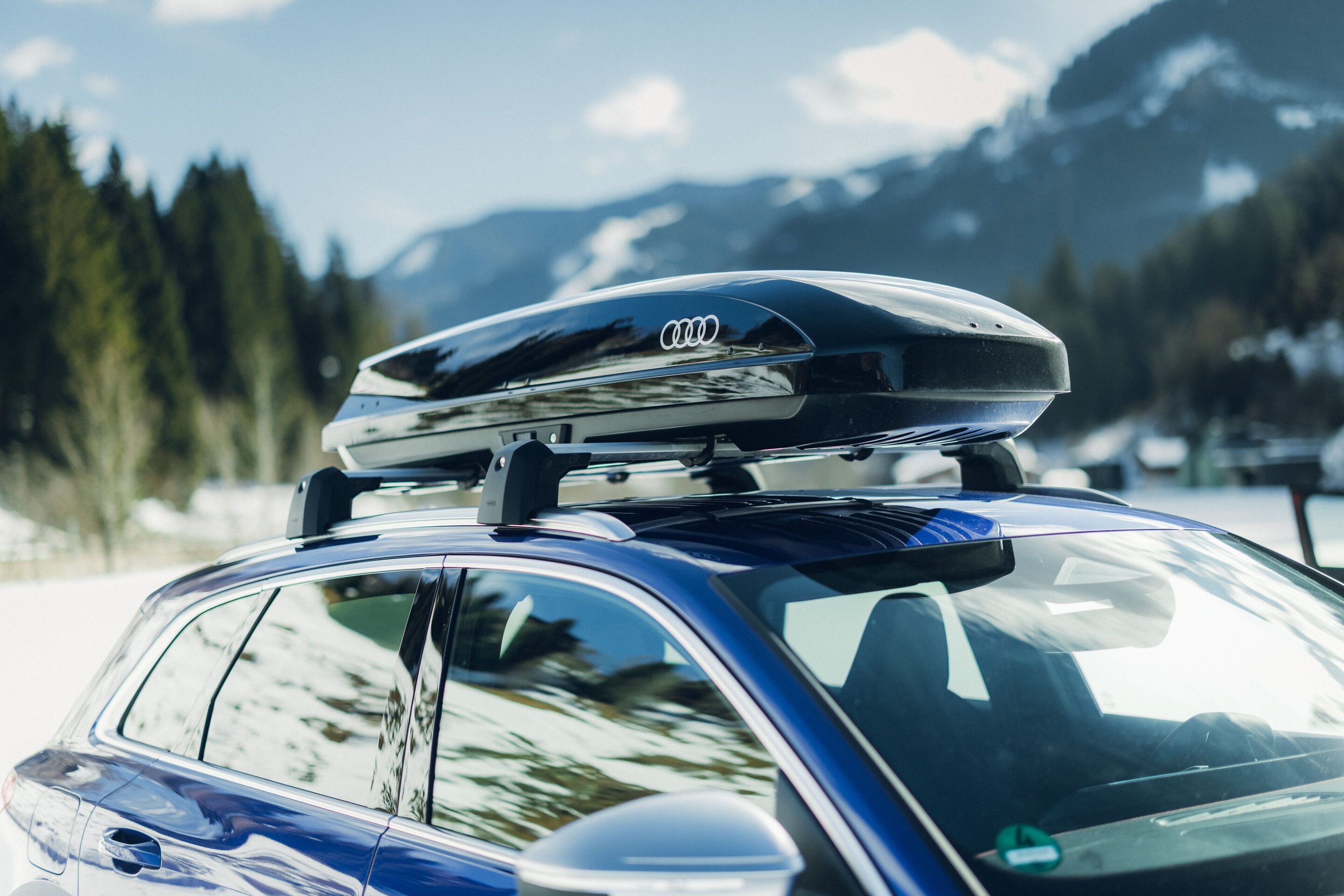 Audi SQ5 - Close-up of an Audi SQ5 in Ultra Blue a black roof cargo box.