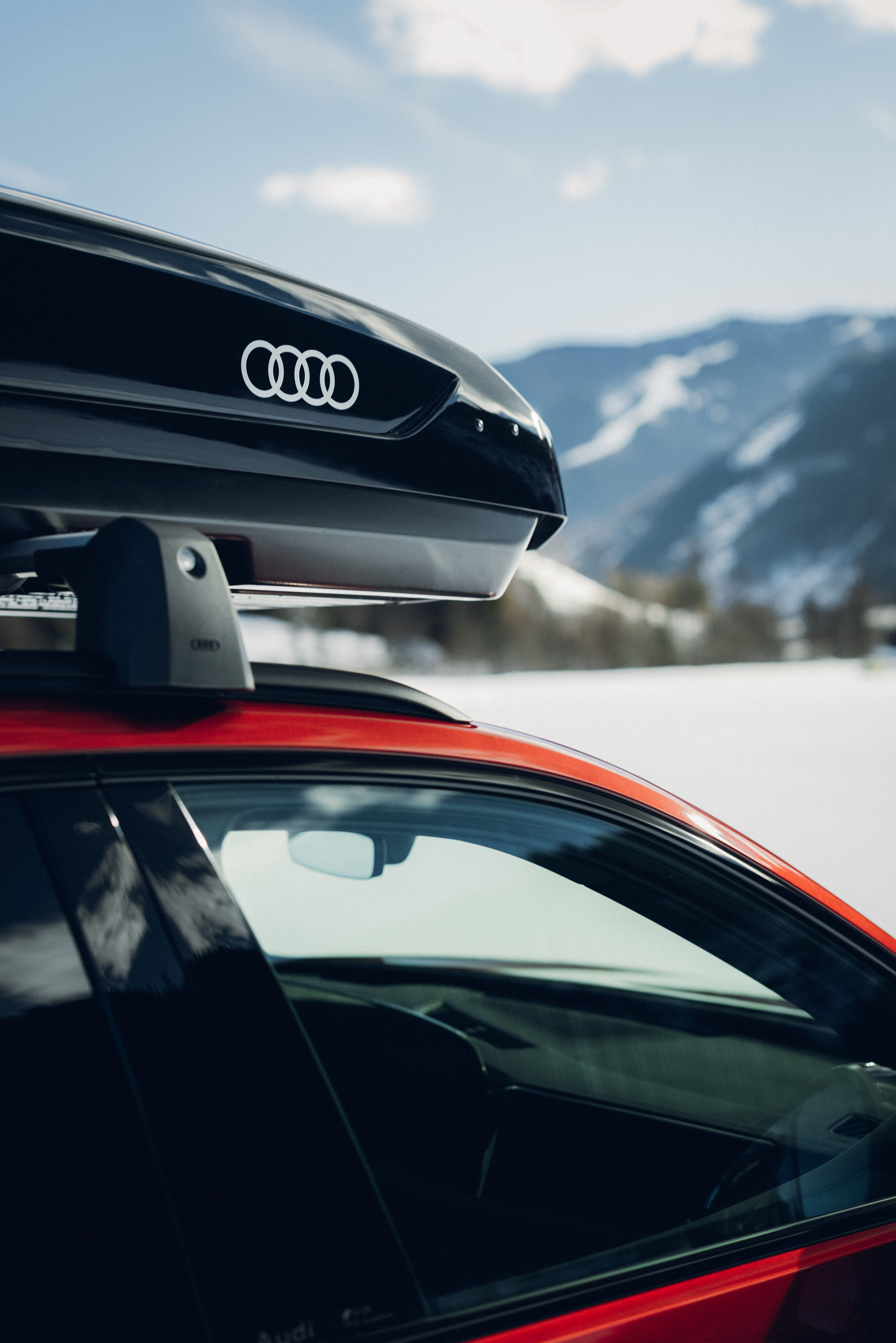 Audi SQ5 - Close-up of an Audi SQ5 in Grenadine Red a black roof cargo box.
