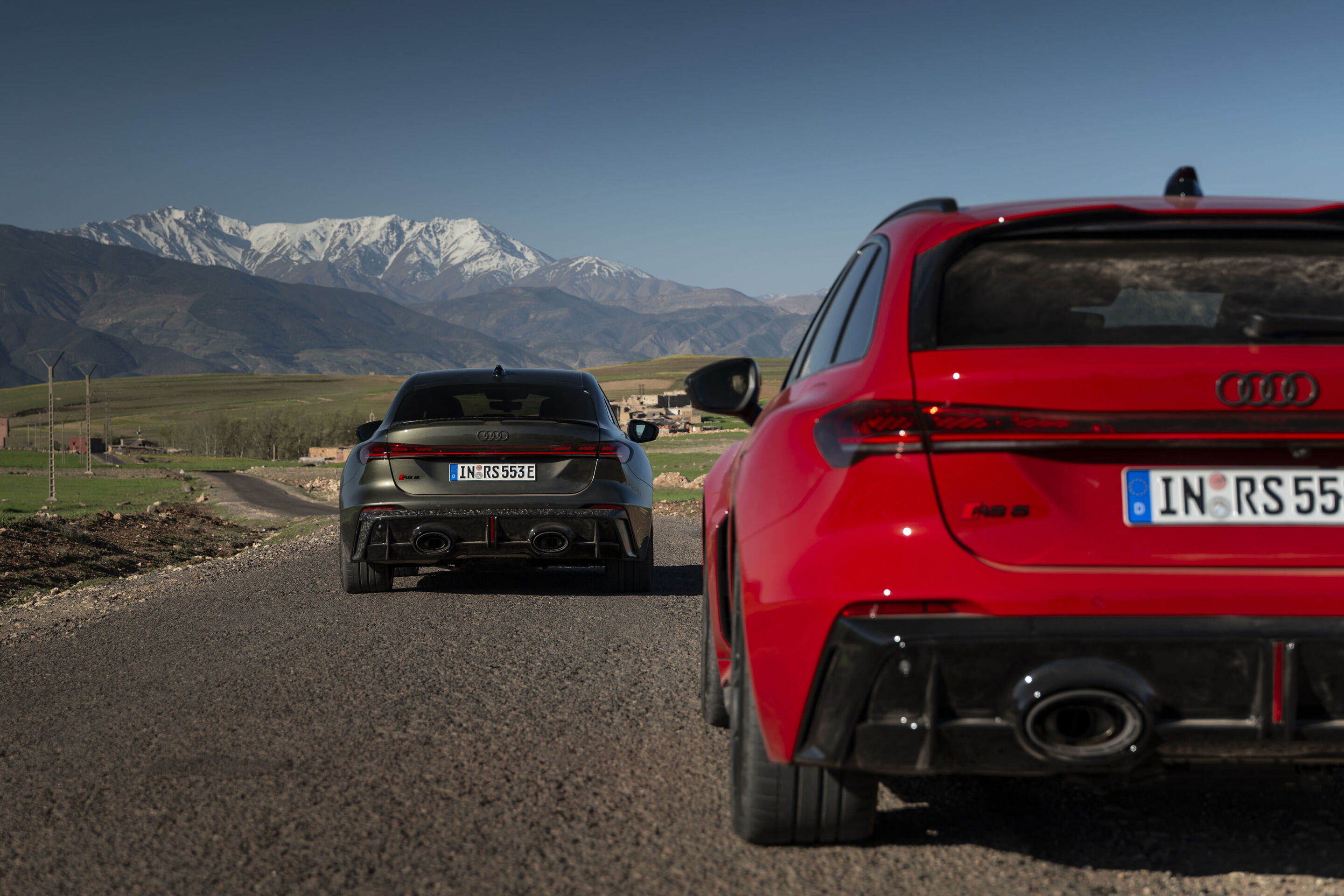 Audi RS 5 Sedan / Audi RS 5 Avant - The Audi RS 5 Sedan in Bedford green and the Audi RS 5 Avant in Progressiv red on an open country road framed by the Atlas Mountains.