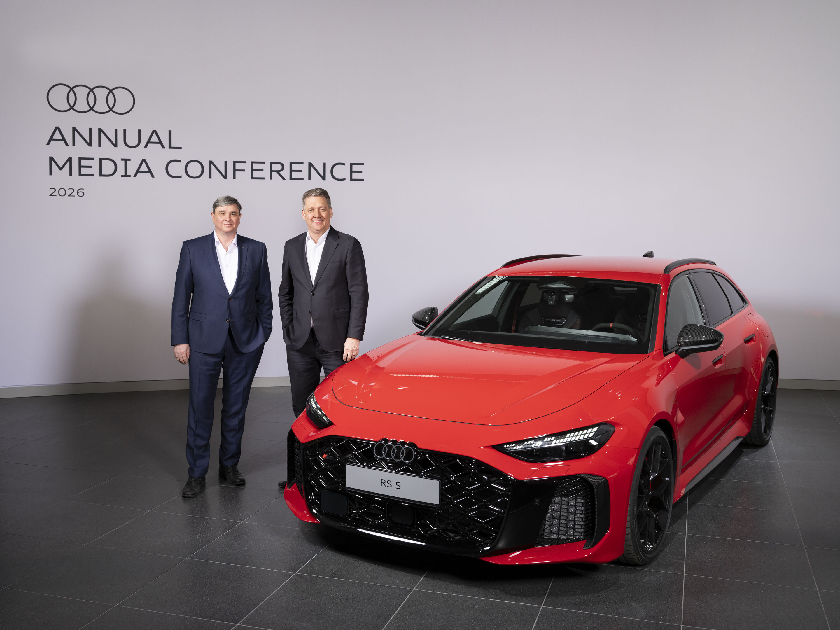 Audi Annual Media Conference 2026 - Jürgen Rittersberger, Member of the Board of Management for Finance, Legal Affairs and IT, and Gernot Döllner, Chairman of the Board of Management (from the left) next to the Audi RS 5 Avant in Progressiv red metallic
