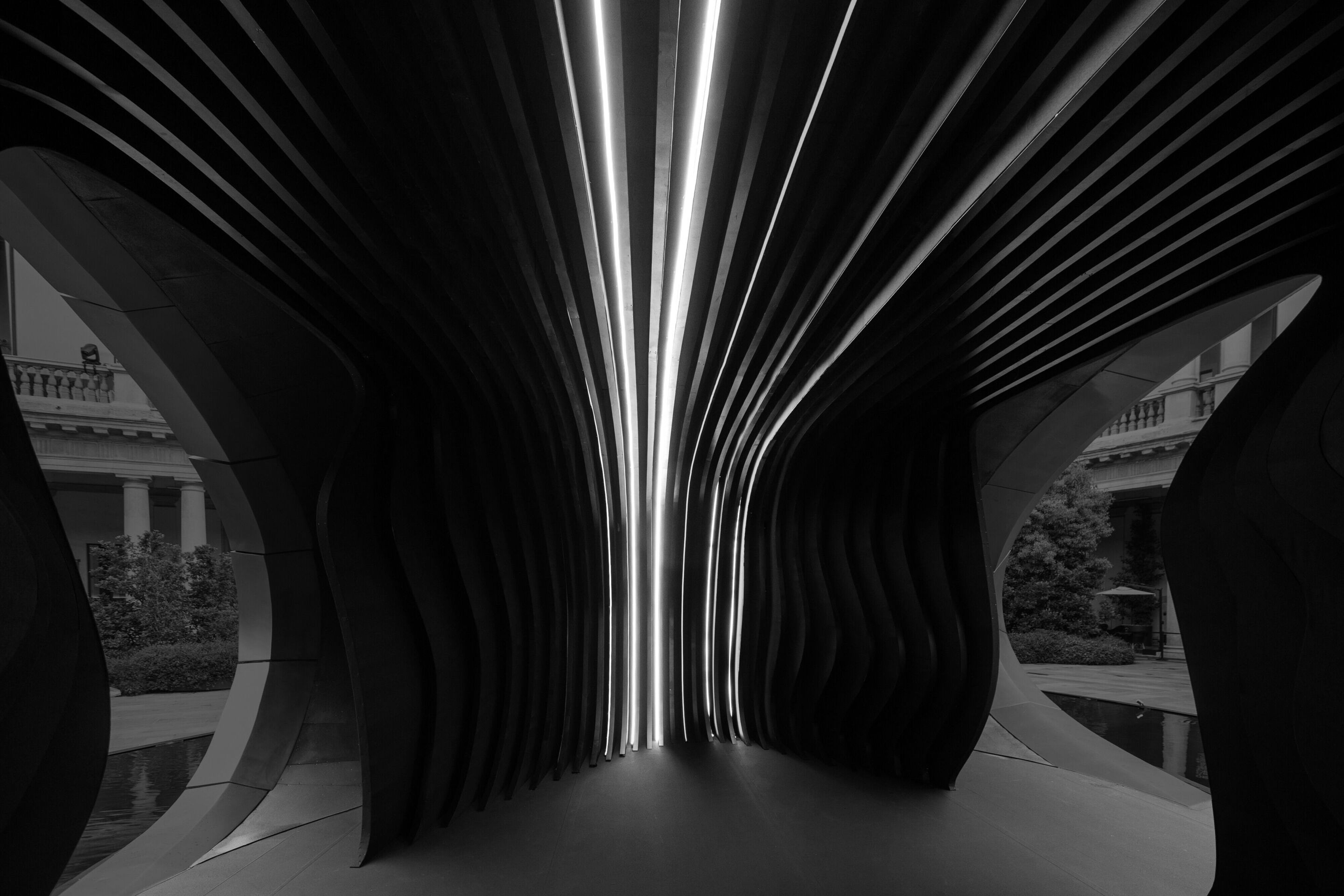 Audi at Milan Design Week 2026 - Interior view of the installation “Origin”. The interplay of light, material and spatial composition creates an immersive environment that invites visitors to focus their perception and experience a moment of calm within...