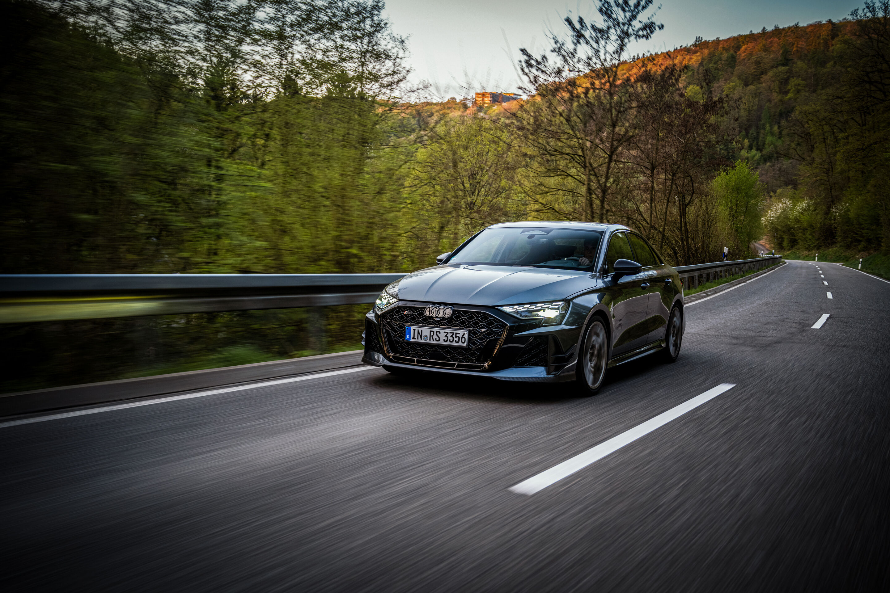 50 years of the Audi five-cylinder - An Audi RS3 competition limited drives on a two-lane road.