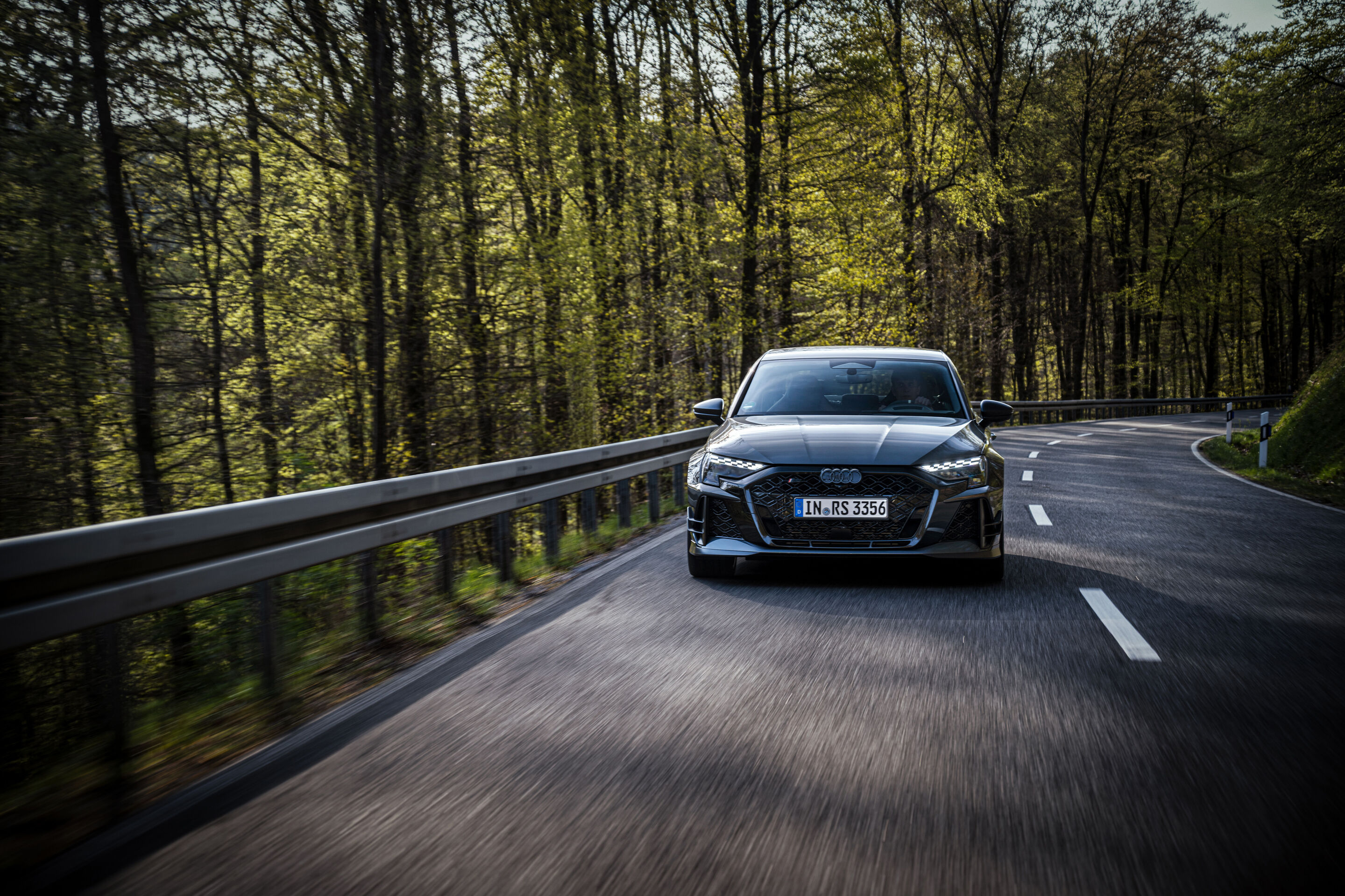 50 years of the Audi five-cylinder - An Audi RS3 competition limited drives on a winding forest road.