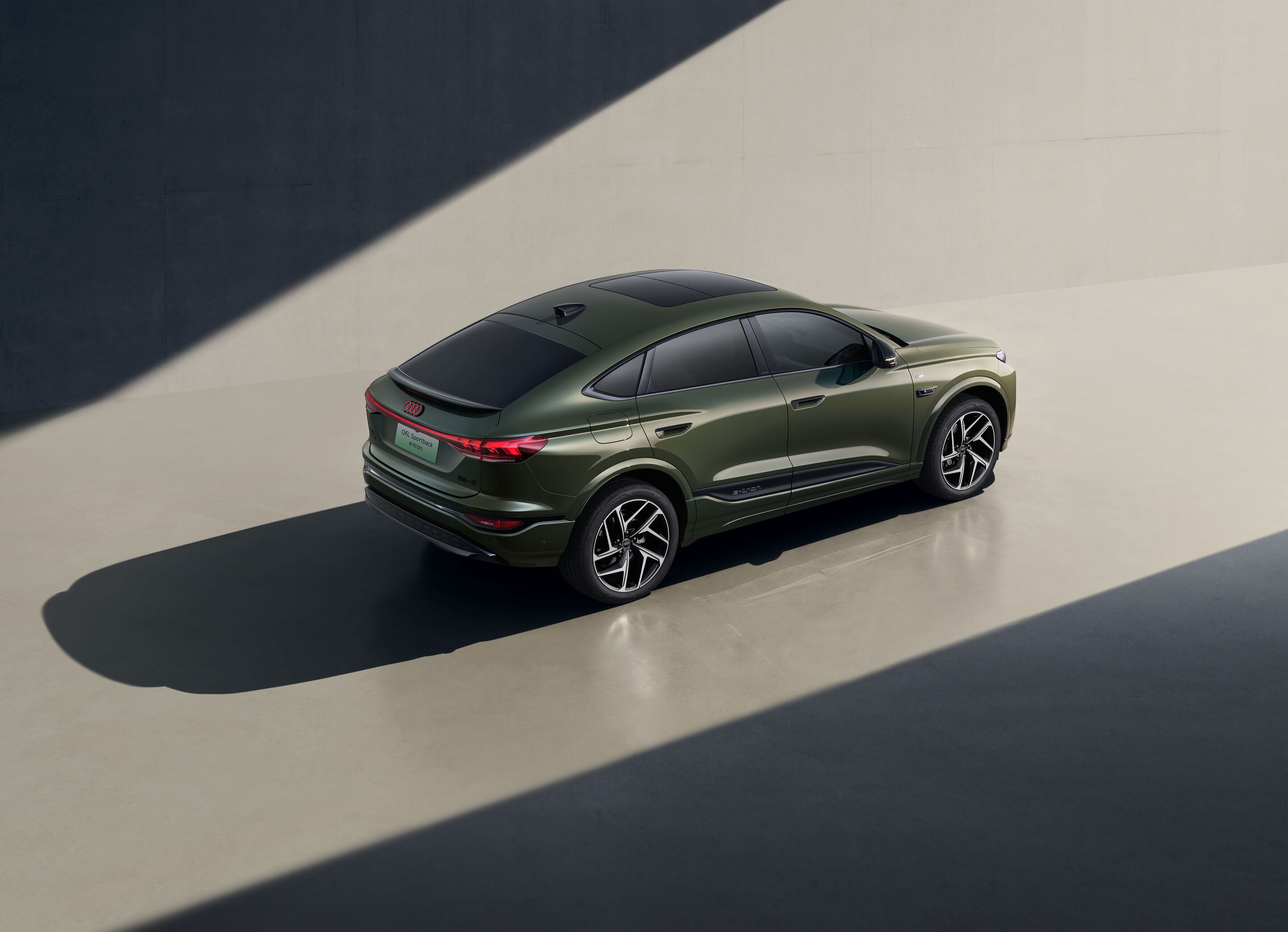 Audi at Auto China 2026 - Audi Q6L Sportback e-tron, studio static shot, exterior, elevated three-quarter rear view with light and shadow staging