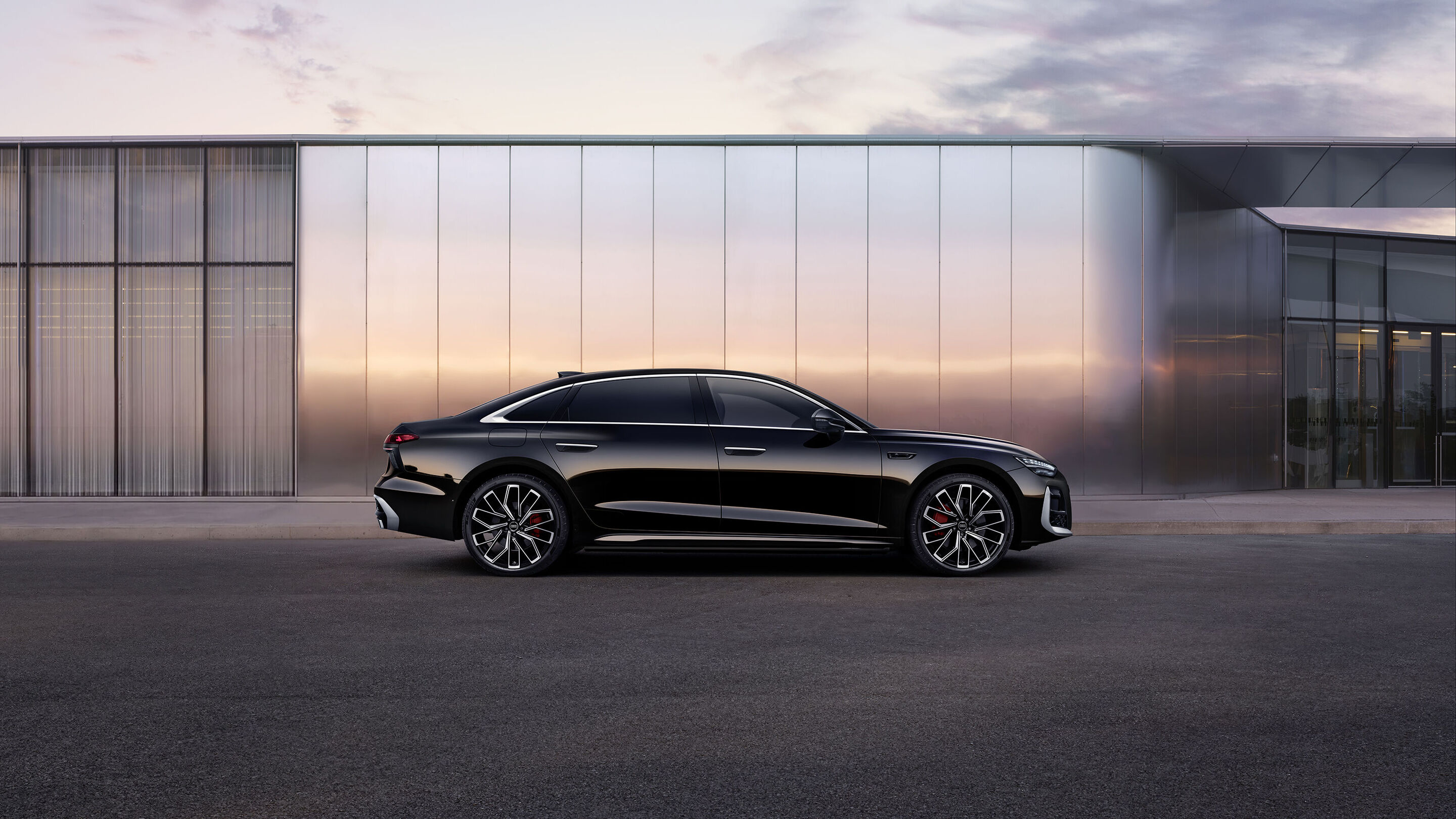 Audi at Auto China 2026 - Audi A6L, outdoor static shot, exterior, side view in front of a reflective building façade