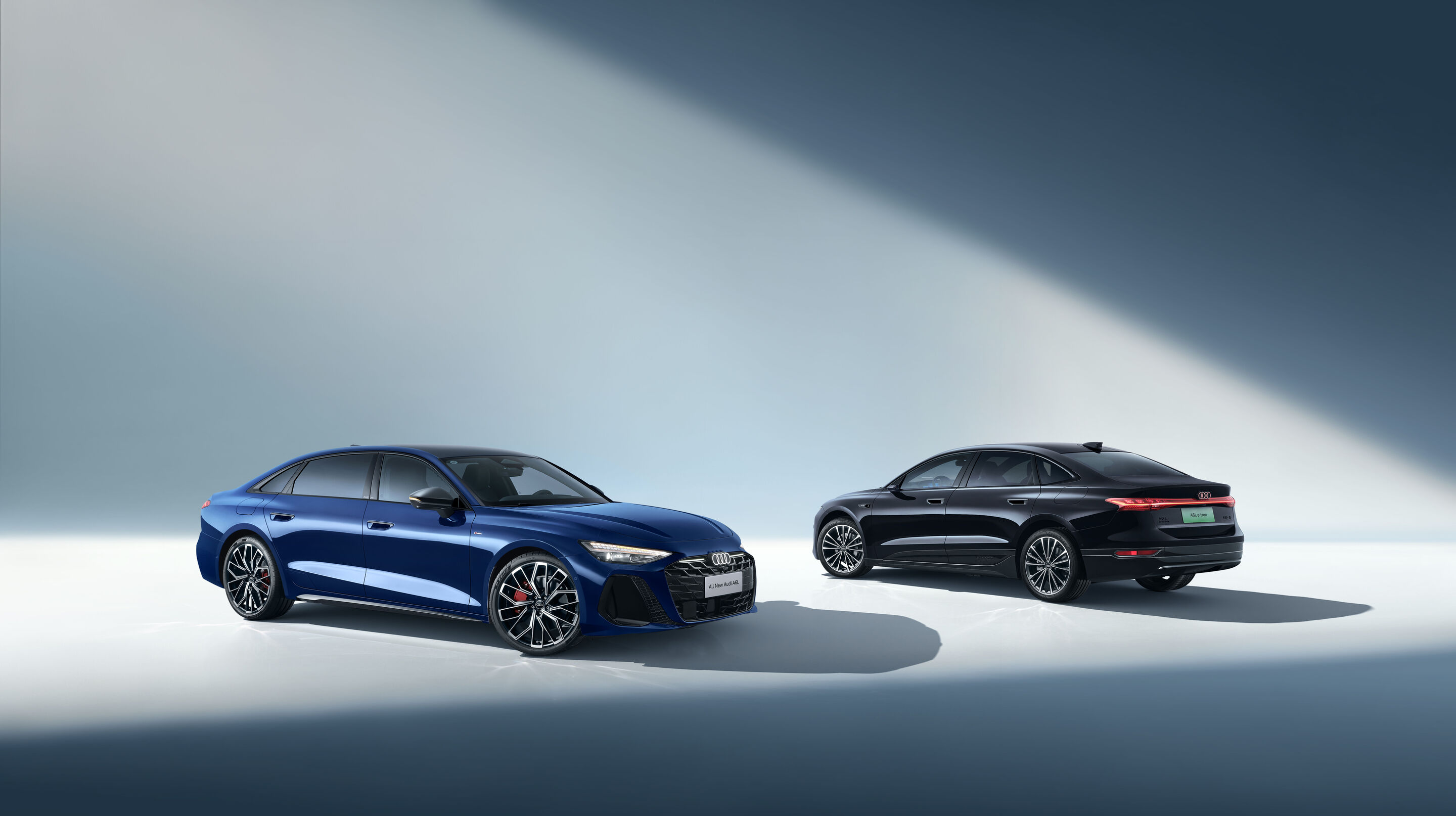 Audi at Auto China 2026 - From left in the image: Audi A6L, Audi A6L e-tron, studio static photo, exterior, each shown in three-quarter front and three-quarter rear view