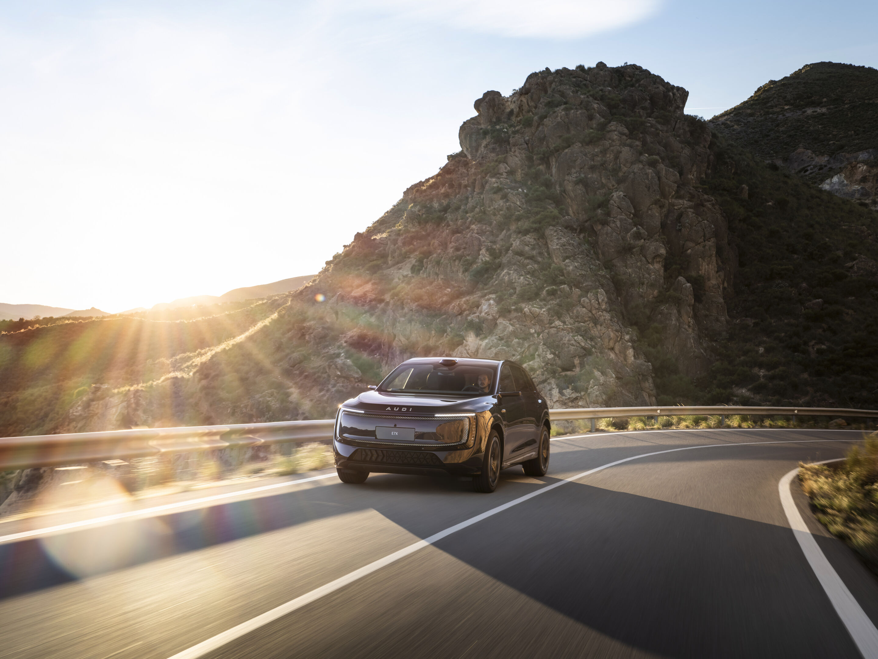 Audi at Auto China 2026 - Audi E7X, outdoor dynamic shot, exterior, front view on a winding mountain road