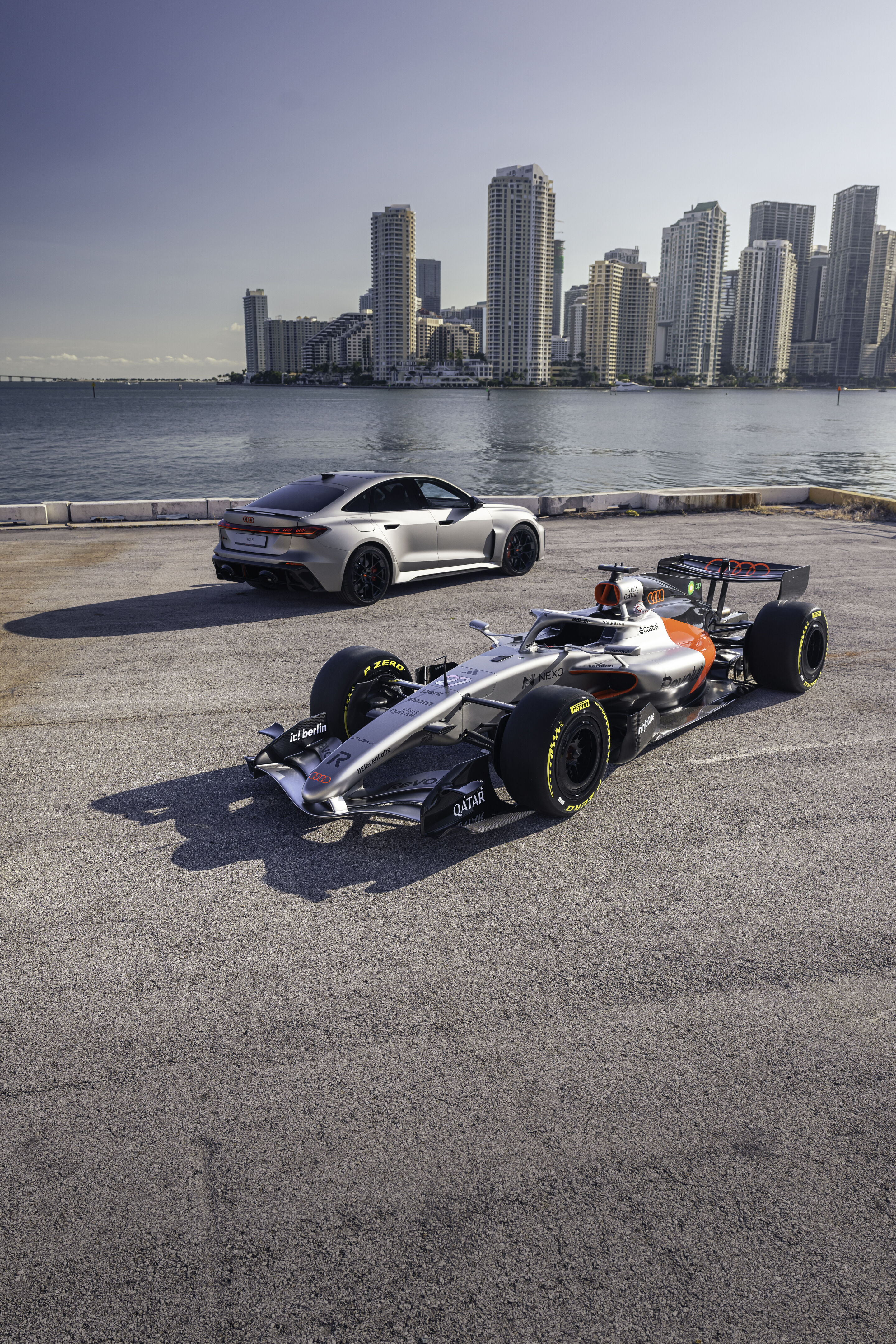 Audi RS 5: Debut as hot-lap car at Formula 1 - The Audi RS 5 next to the Audi R26 in front of the skyline of Miami. The RS 5 makes its debut at the Formula 1 Miami Grand Prix as a car for the F1® Pirelli Hot Laps