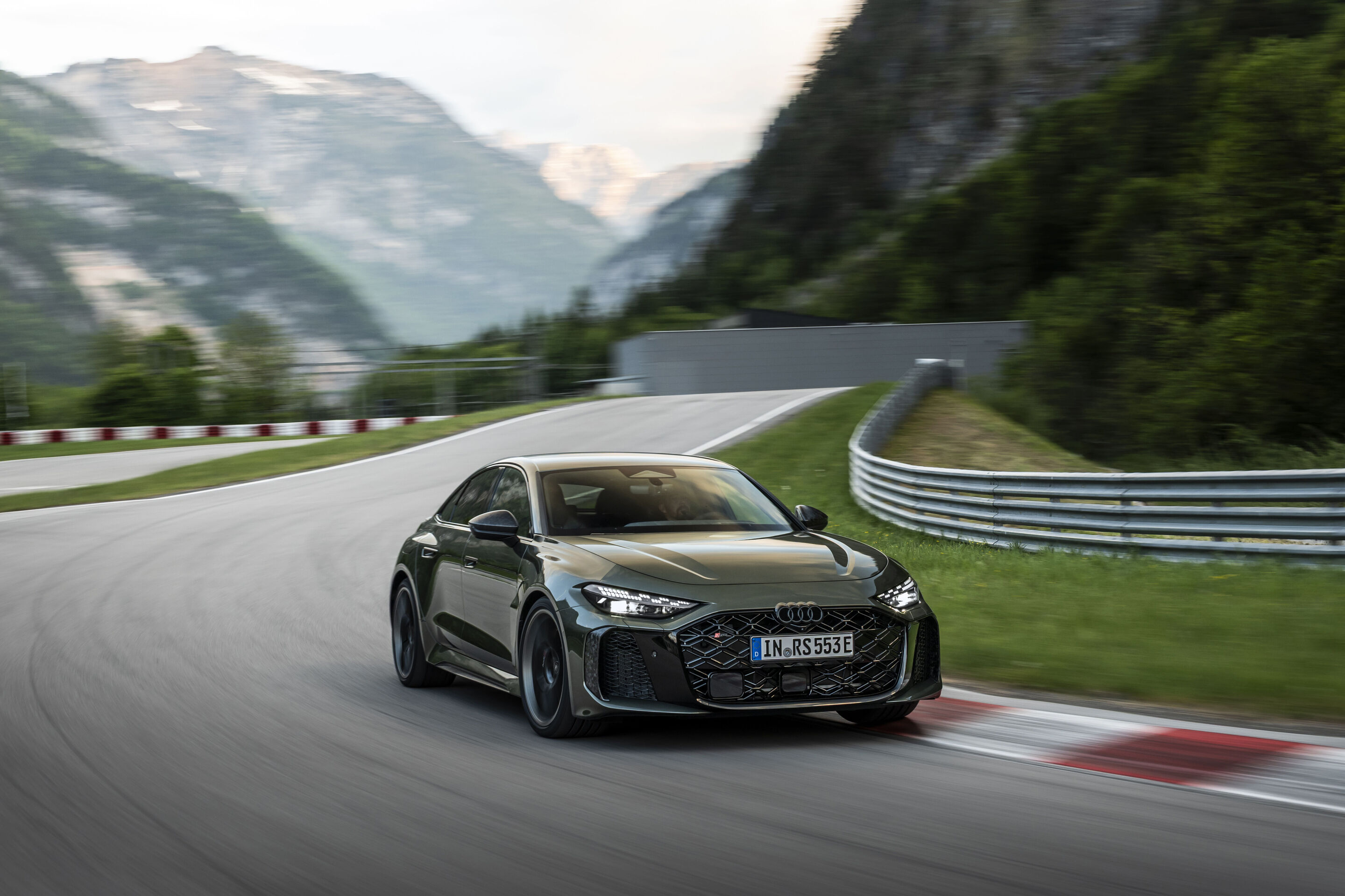 Audi RS 5 Sedan - Audi RS 5 Sedan in Bedford green, outdoor driving shot, exterior, three-quarter front view on a winding mountain road.