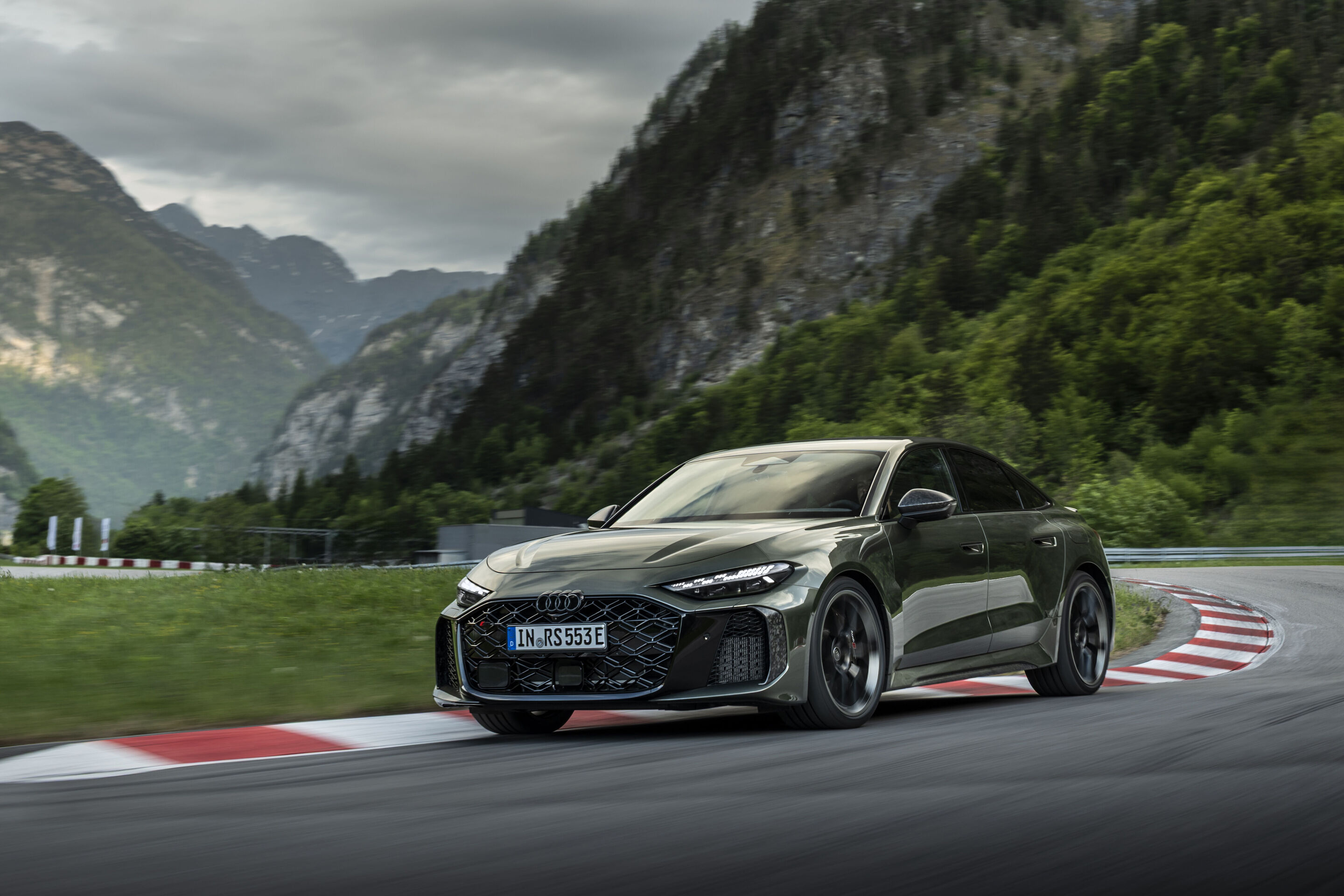 Audi RS 5 Sedan - Audi RS 5 Sedan in Bedford green, outdoor driving shot, exterior, front view during dynamic cornering.