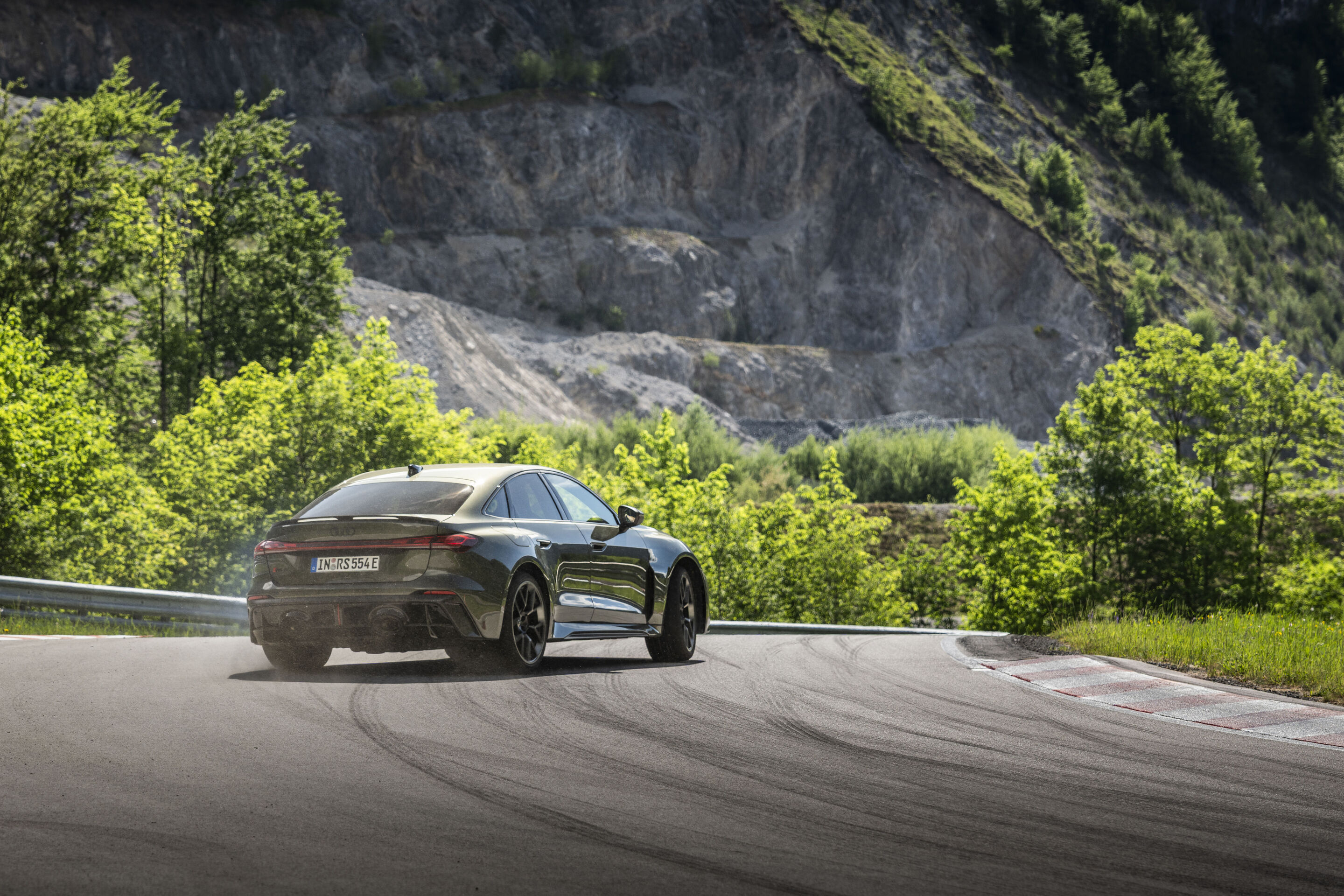 Audi RS 5 Sedan - Audi RS 5 Sedan in Bedford green, outdoor driving shot, exterior, rear view during sporty cornering.
