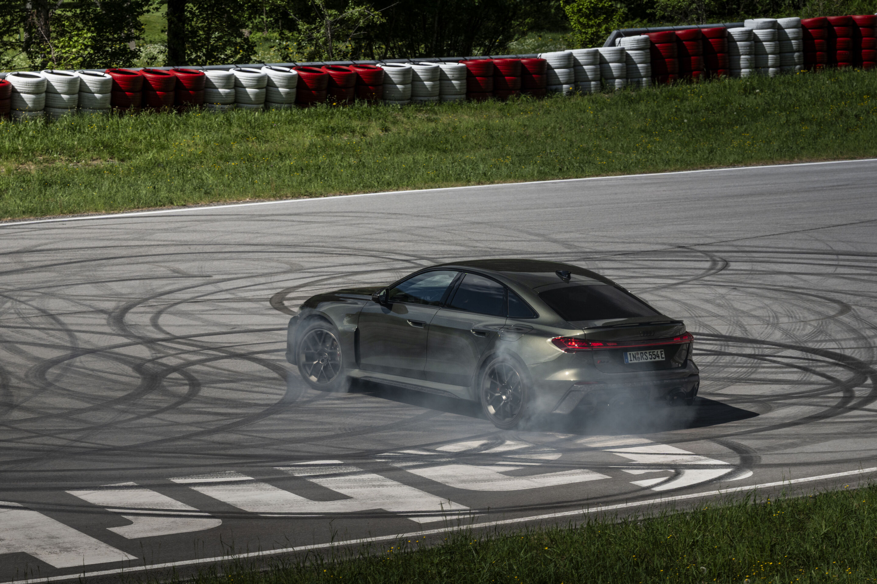 Audi RS 5 Sedan - Audi RS 5 Sedan in Bedford green, outdoor driving shot, exterior, rear view during a dynamic drift.