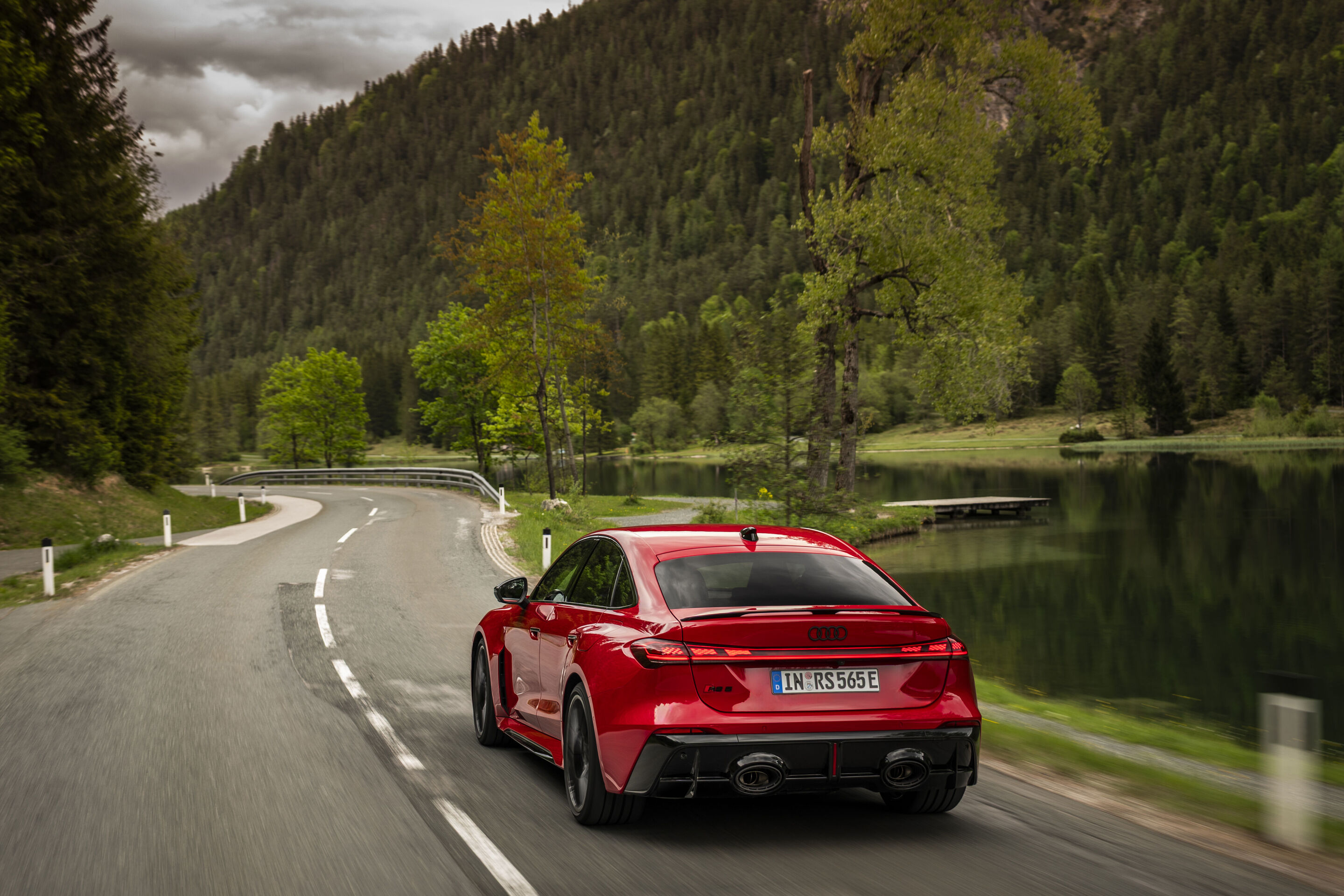 Audi RS 5 Sedan - Audi RS 5 Sedan in Progressive red, outdoor driving shot, exterior, rear view on a winding country road.