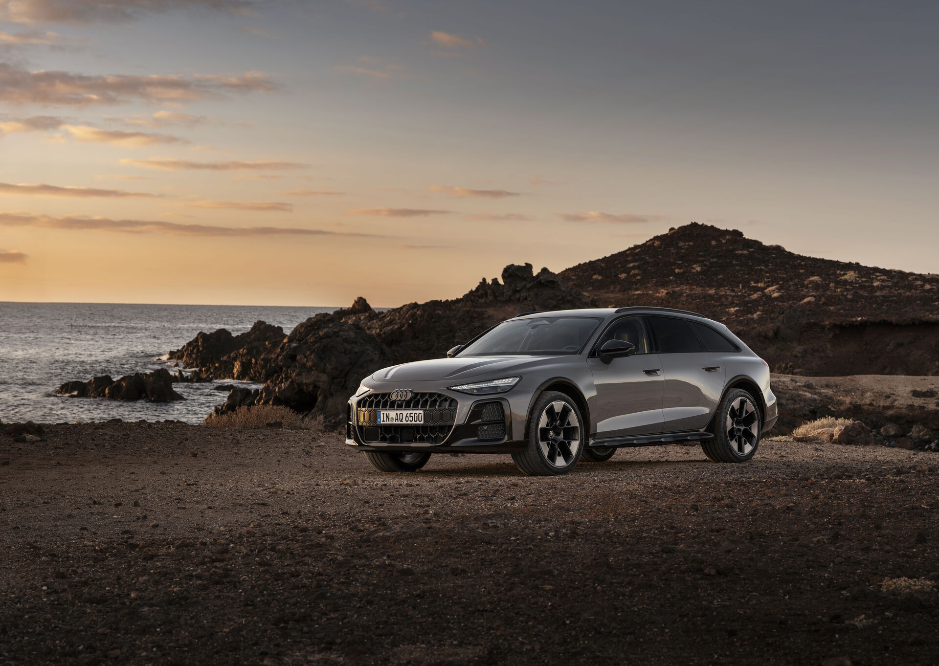 Official Audi MediaCenter image of the new Audi A6 allroad in side view on a rugged coastal road