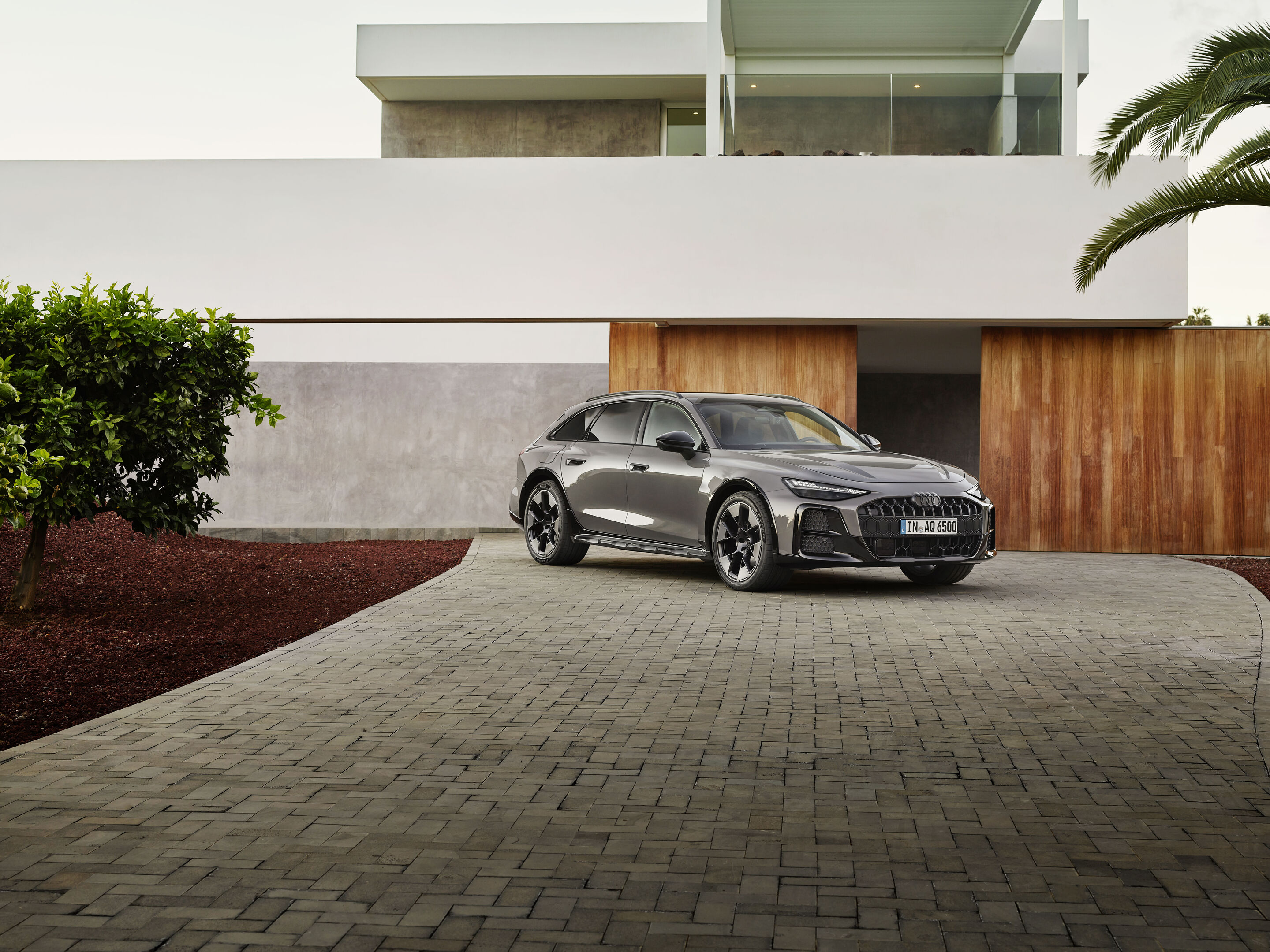 Audi A6 allroad quattro - Audi A6 allroad (plateau grey metallic) front view in modern architecture (static shot).