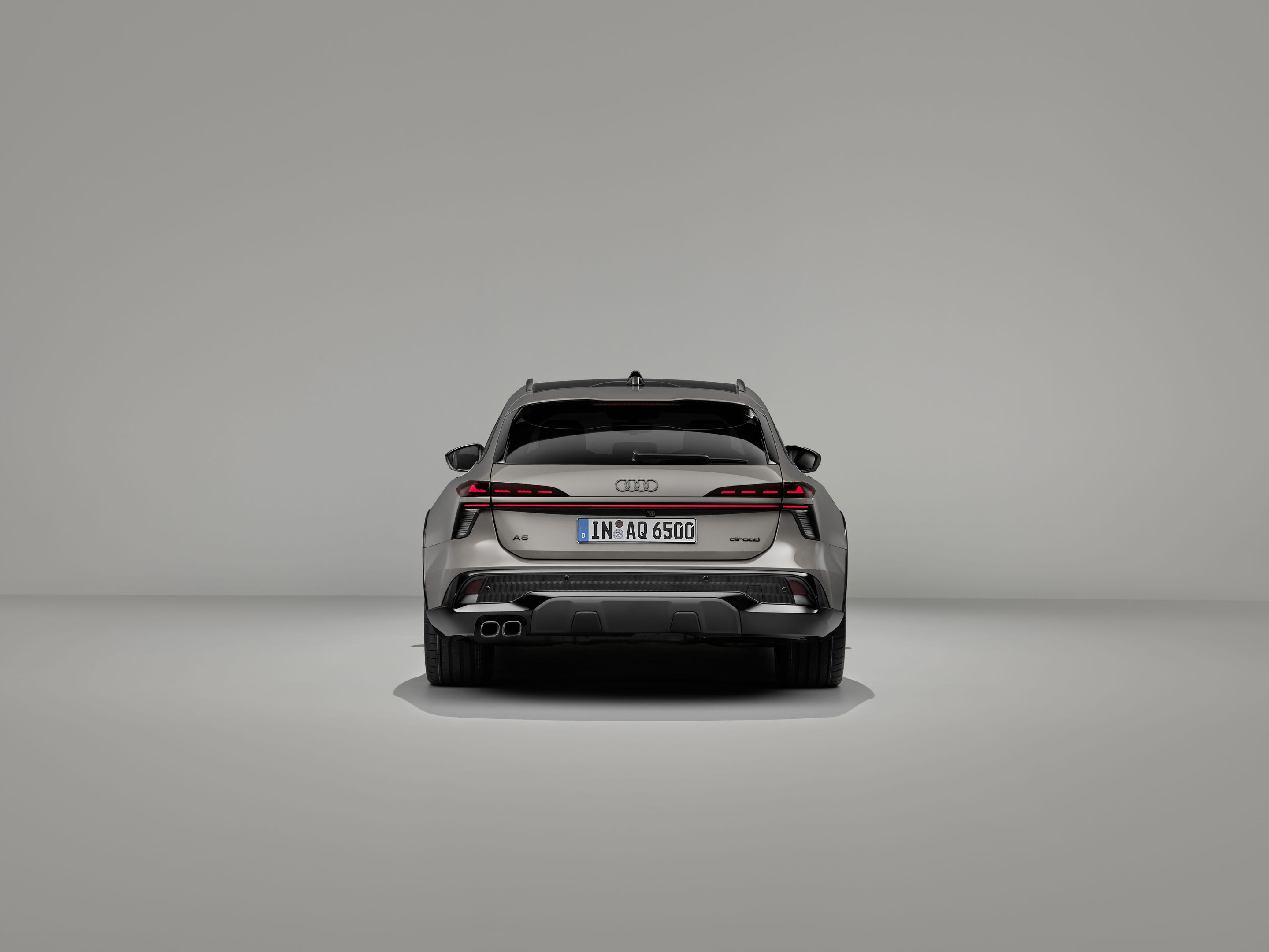 Audi A6 allroad quattro - Audi A6 allroad (plateaugrau metallic) in Heckansicht: Die digitalen OLED-Heckleuchten 2.0 und der kraftvolle Diffusor unterstreichen die Präsenz am Fahrzeugheck.