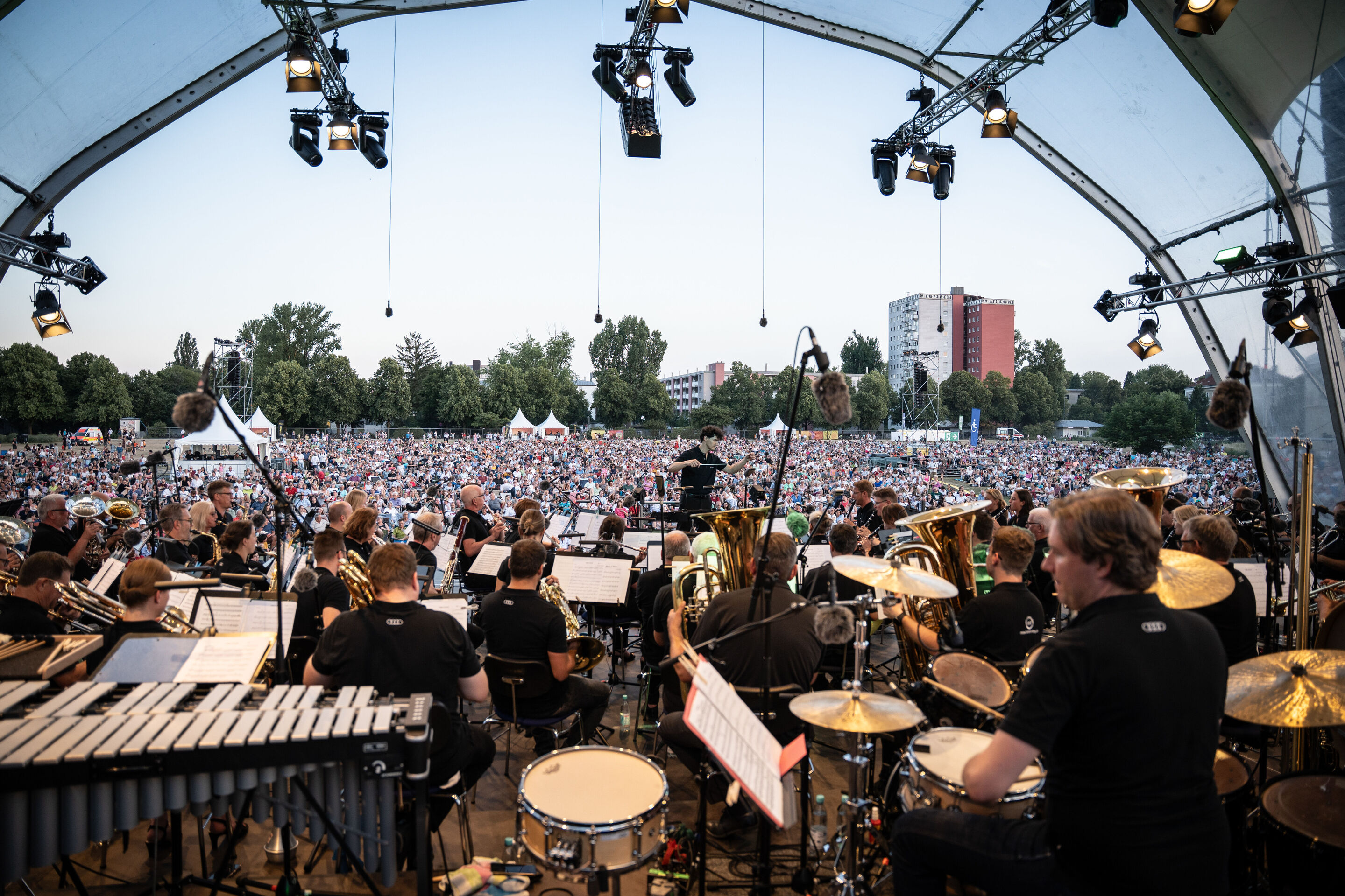 The Audi Wind Orchestra at the opening concert/classical open-air concert in Klenzepark - View from the stage across the Audi Wind Philharmonic to the audience of around 6,000 at the Classical Open-Air Concert 2026 in Klenzepark. The orchestra performs...