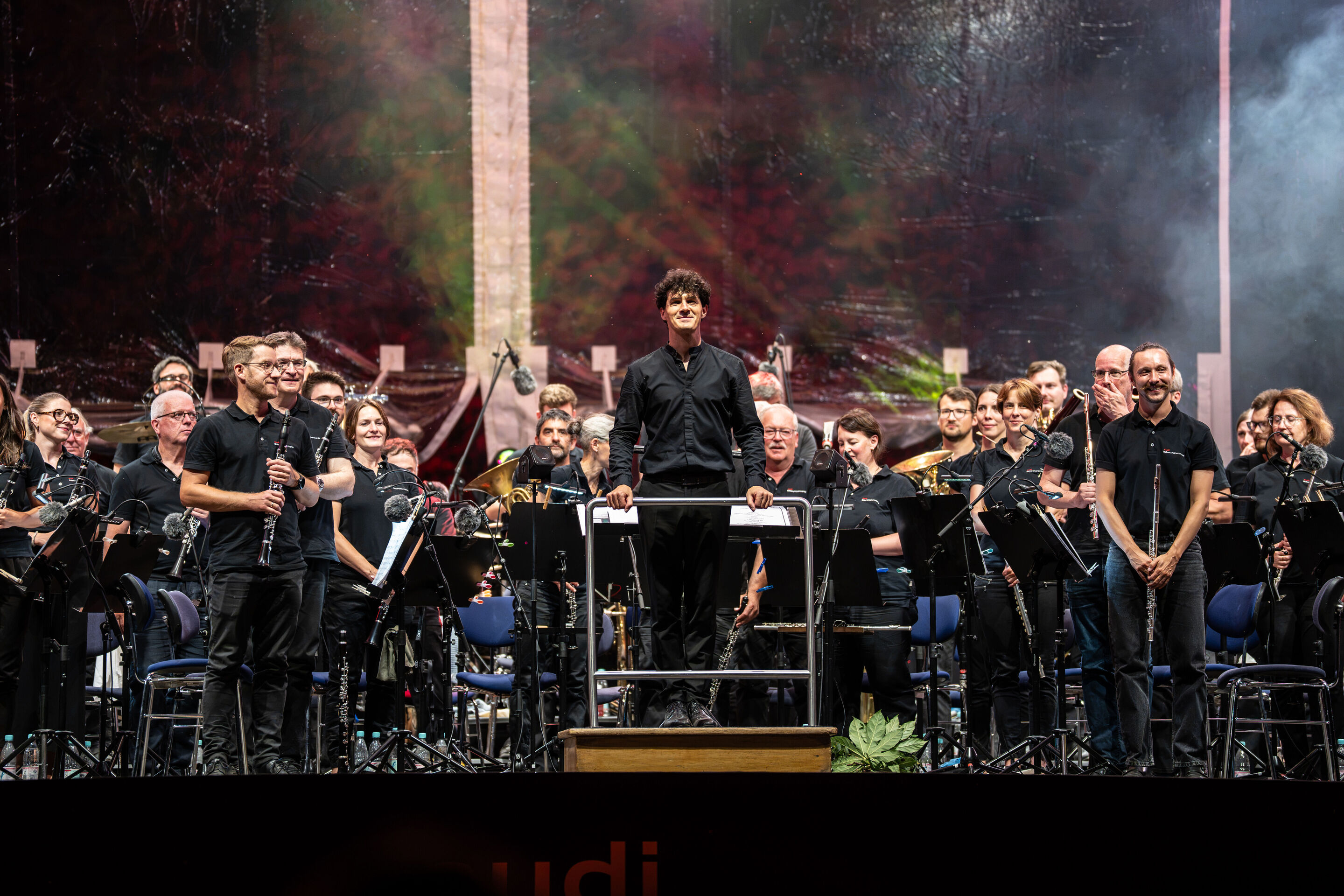 The Audi Wind Orchestra at the opening concert/classical open-air concert in Klenzepark - On stage at the 2026 Classical Open-Air Concert in Klenzepark, conductor Mathias Wehr stands on the podium, surrounded by the musicians of the Audi Wind Philharmonic,...