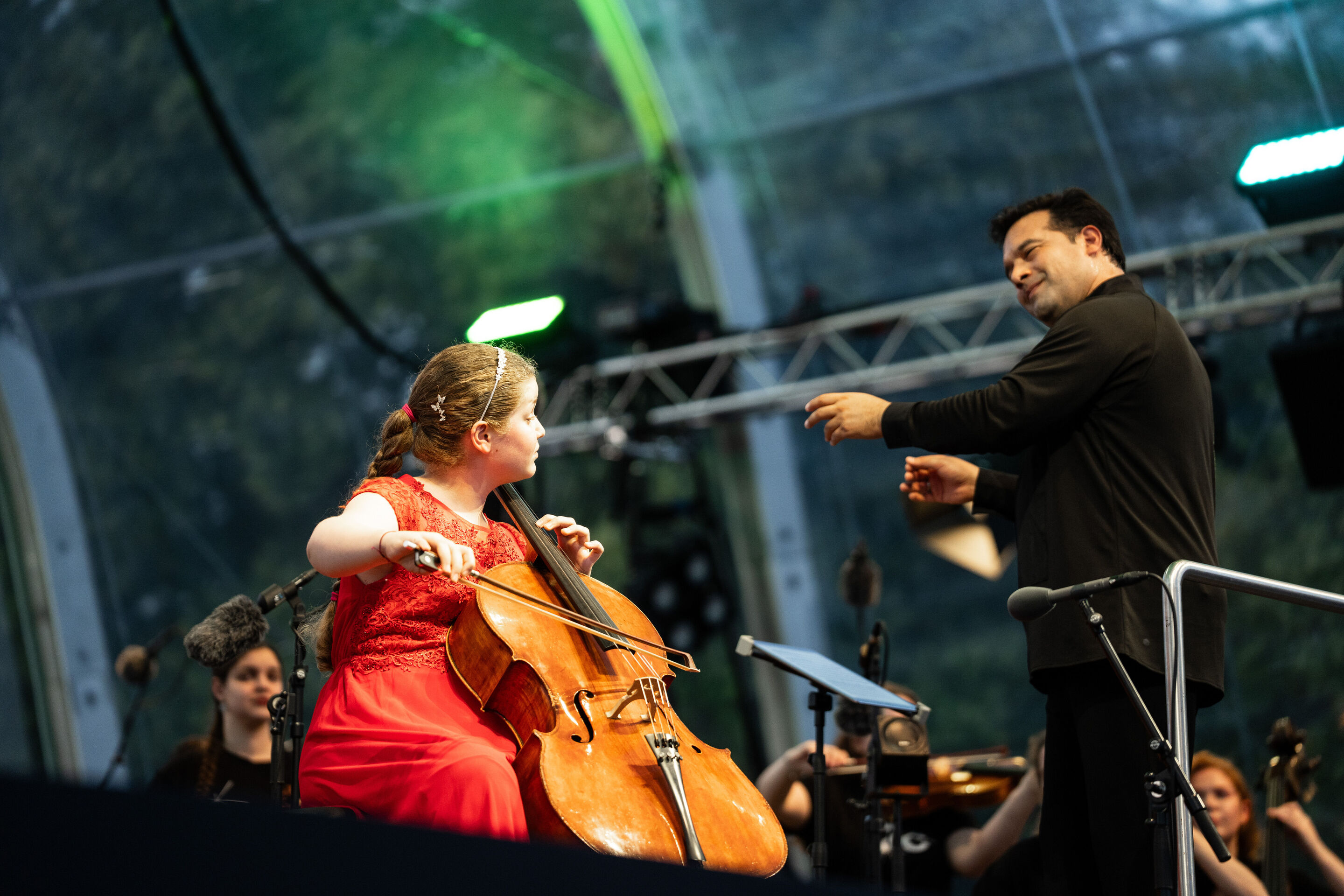 Baltic Sea Philharmonic performing at the classical open-air concert in Klenzepark - Cellist Charlotte Melkonian and conductor Robert Treviño at the 2026 Classical Open-Air Concert in Klenzepark during a performance with the Baltic Sea Philharmonic.