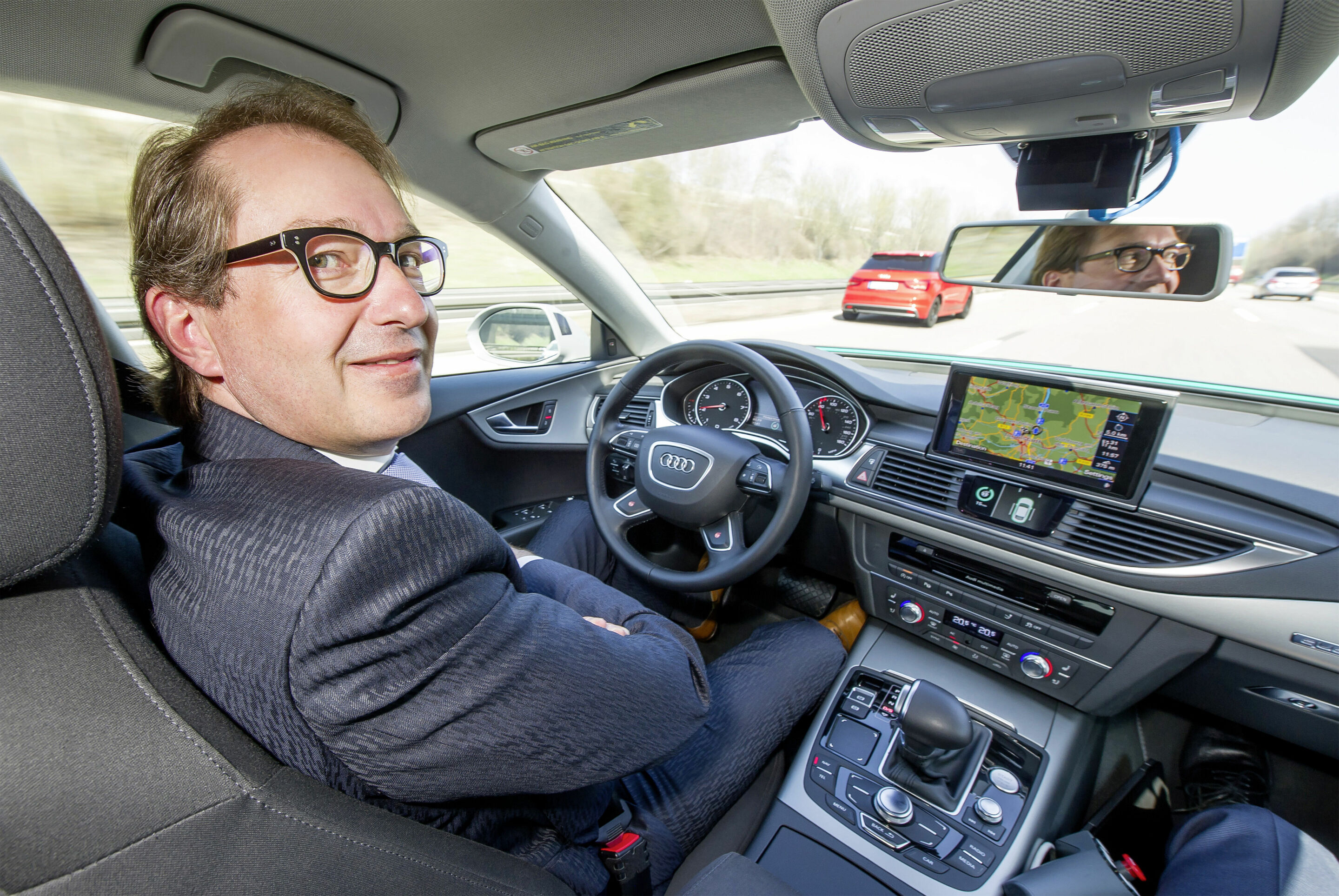 Bundesverkehrsminister Alexander Dobrindt testet pilotiert fahrenden Audi